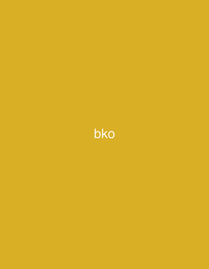 The image displays a solid, uniform background in a shade of mustard yellow or goldenrod. Centered on this monochromatic field is the white, sans-serif text "bko". No individuals, additional subjects, objects beyond the text, or specific actions or interactions are visible. The scene lacks any environmental details or geographical markers that would provide context for a location, including the city of Casablanca, Morocco.