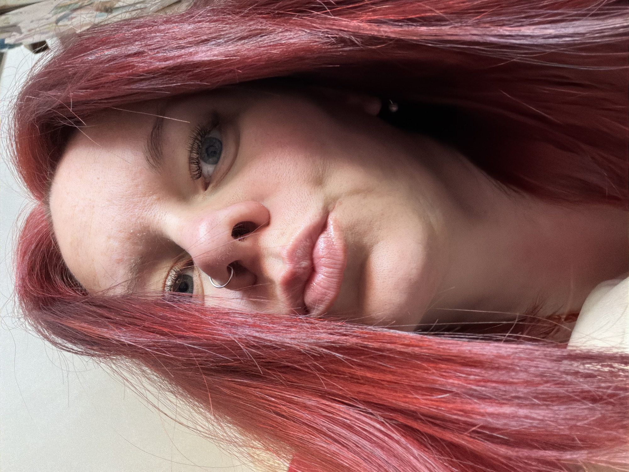 A close-up portrait of a fair-skinned person with red hair, tilted to the left. The individual has blue eyes and a nose piercing. No specific information indicates the location is Chaikovsky, Russia.