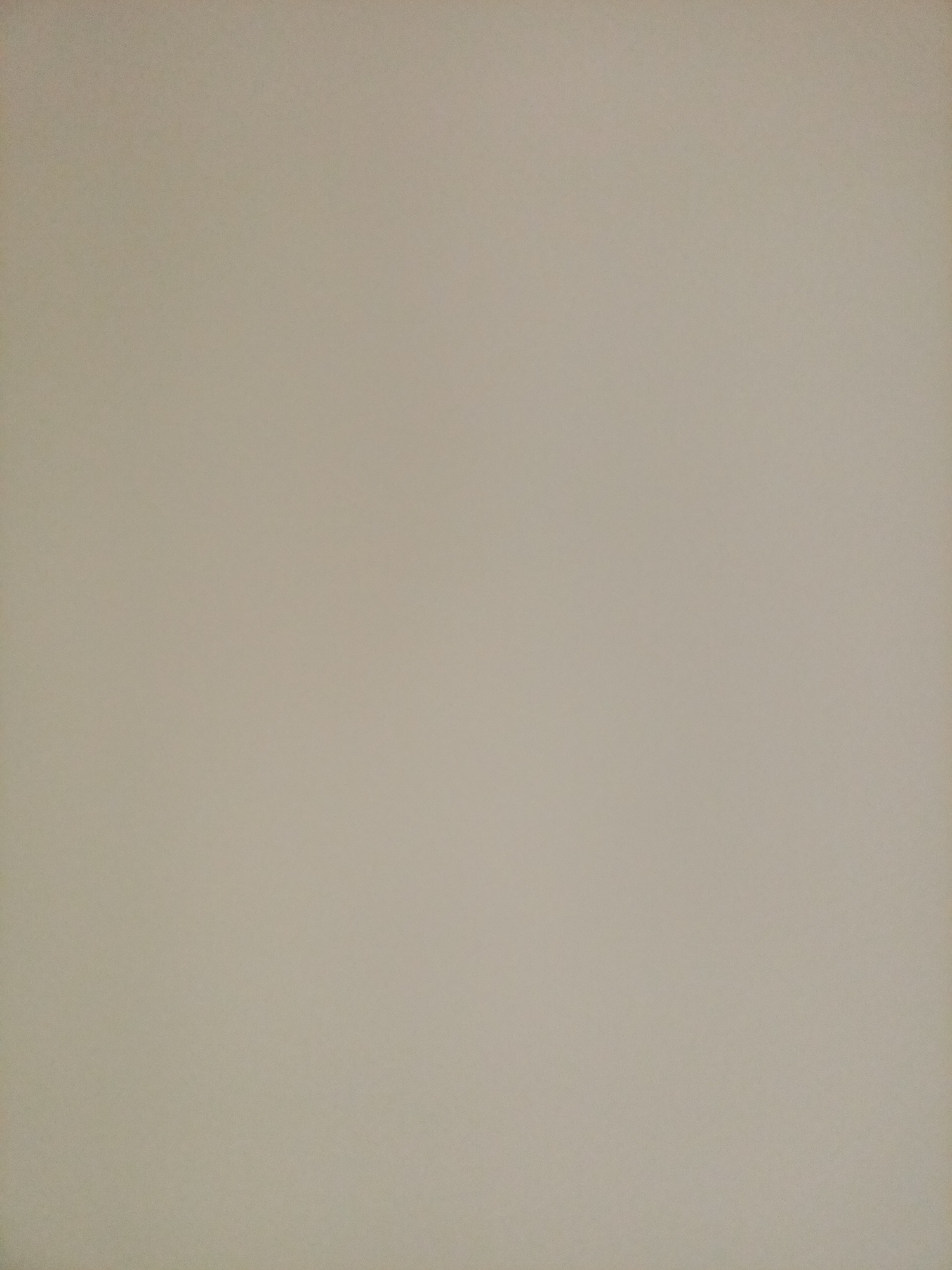 The image depicts a plain, neutral-colored wall, likely interior, exhibiting a subtle texture. No elements of Rostov-on-Don, Russia, are discernible within the frame.
