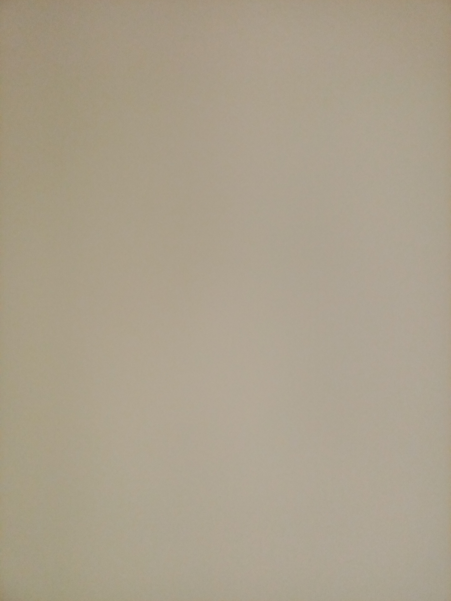 The image is a close-up, slightly blurry, and overcast shot of a plain beige wall. There are no discernible objects, people, or actions visible in the image, nor any contextual clues that would allow for identification of its location in Rostov-on-Don, Russia. The lighting is soft and diffused, with no harsh shadows. The texture of the wall appears to be slightly uneven, possibly painted plaster.