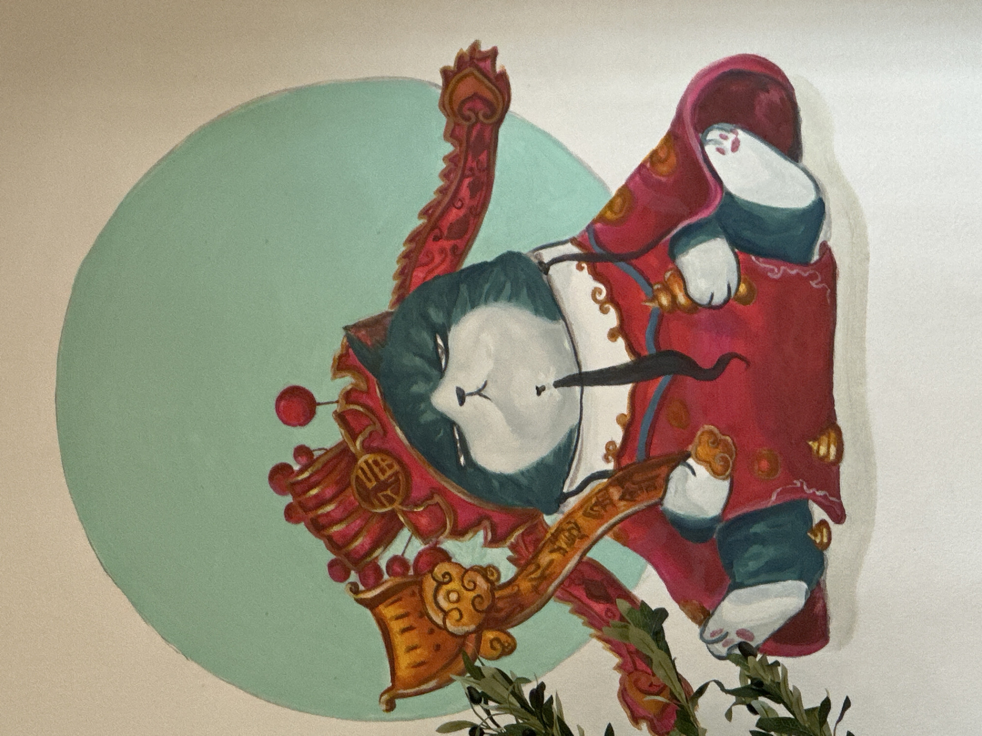 A painting depicts a fat, grumpy-looking cat dressed in elaborate red and gold imperial robes, seated cross-legged against a pale, textured background. The cat has dark teal fur on its head and limbs, with white fur on its chest and paws. It wears a red and gold crown adorned with spherical red embellishments and intricate gold detailing. The cat holds a golden scepter-like object in its left paw and a small golden orb in its right. The robe features gold trim and motifs. In front of the cat are three small, brown, lump-like objects that resemble excrement. To the left of the cat, a sprig of greenery with dark olives is visible, extending from outside the frame. Behind the cat is a large, pale green circular motif. The painting is lit from above, casting a subtle shadow beneath the cat. No people or animals other than the depicted cat are present. The location is not specified within the image or any accompanying context.