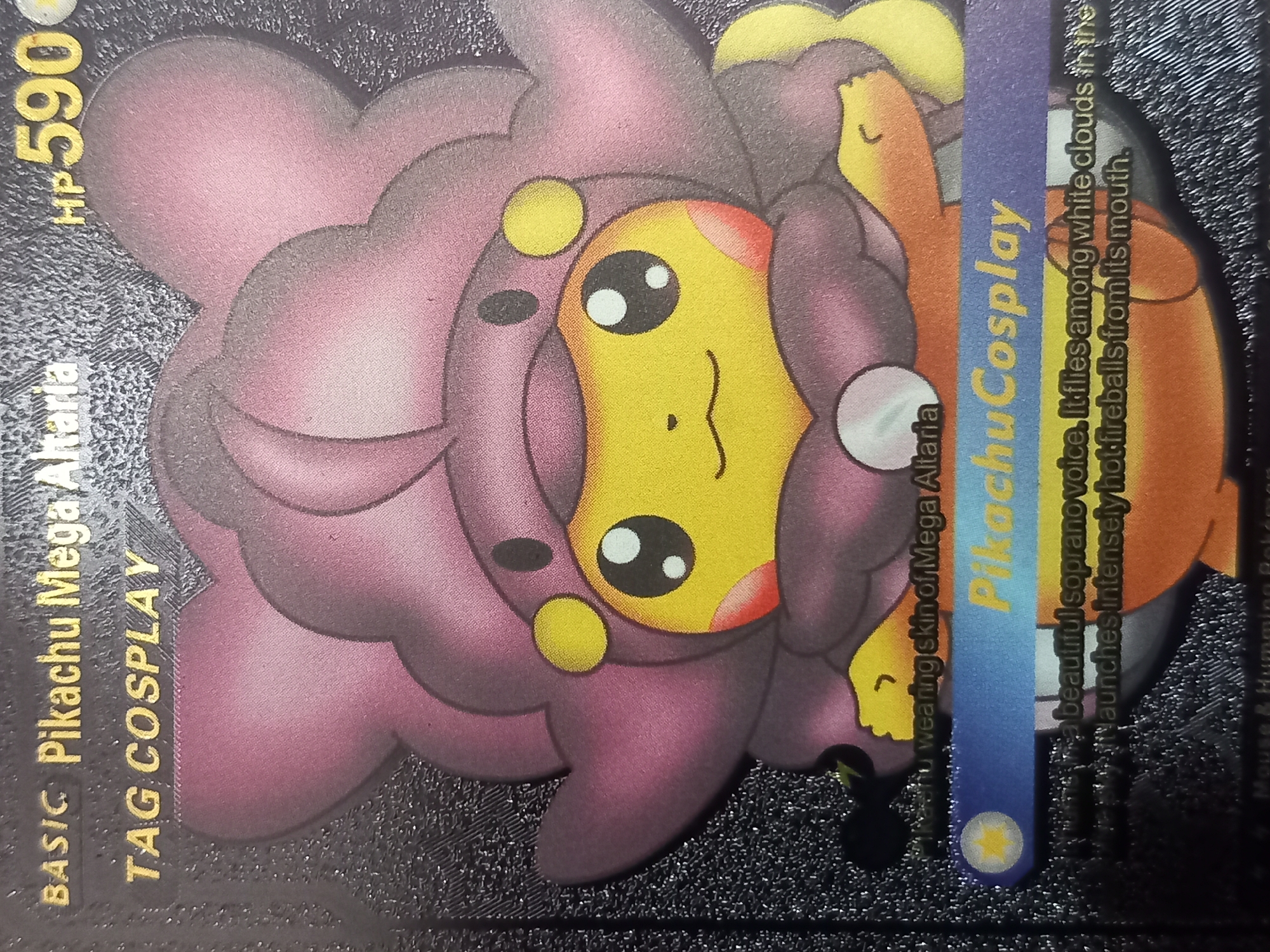 A close-up, eye-level shot shows a Pokemon trading card featuring Pikachu in a cosplay outfit of Mega Altaria. The card has a dark, textured background. The text "BASIC Pikachu Mega Altaria" is at the top left, followed by "TAG COSPLAY" below it. To the right of "Altaria" is "HP 590" in yellow.
The main subject is Pikachu, depicted in its iconic yellow color, wearing a large, purple, cloud-like costume that resembles Mega Altaria's features, including a hood with ear-like protrusions and a fluffy mane. Pikachu's face is visible with large, round eyes and rosy cheeks.
Below the main image, there is a blue banner with yellow text that reads "PikachuCosplay". Further down, there are lines of text describing the Pokemon's abilities and characteristics. The description mentions "beautiful soprano voice" and launching "intensely hot fireballs from its mouth." The bottom edge of the card shows faint text that appears to be copyright information. The lighting is even, and the focus is sharp on the card's details.