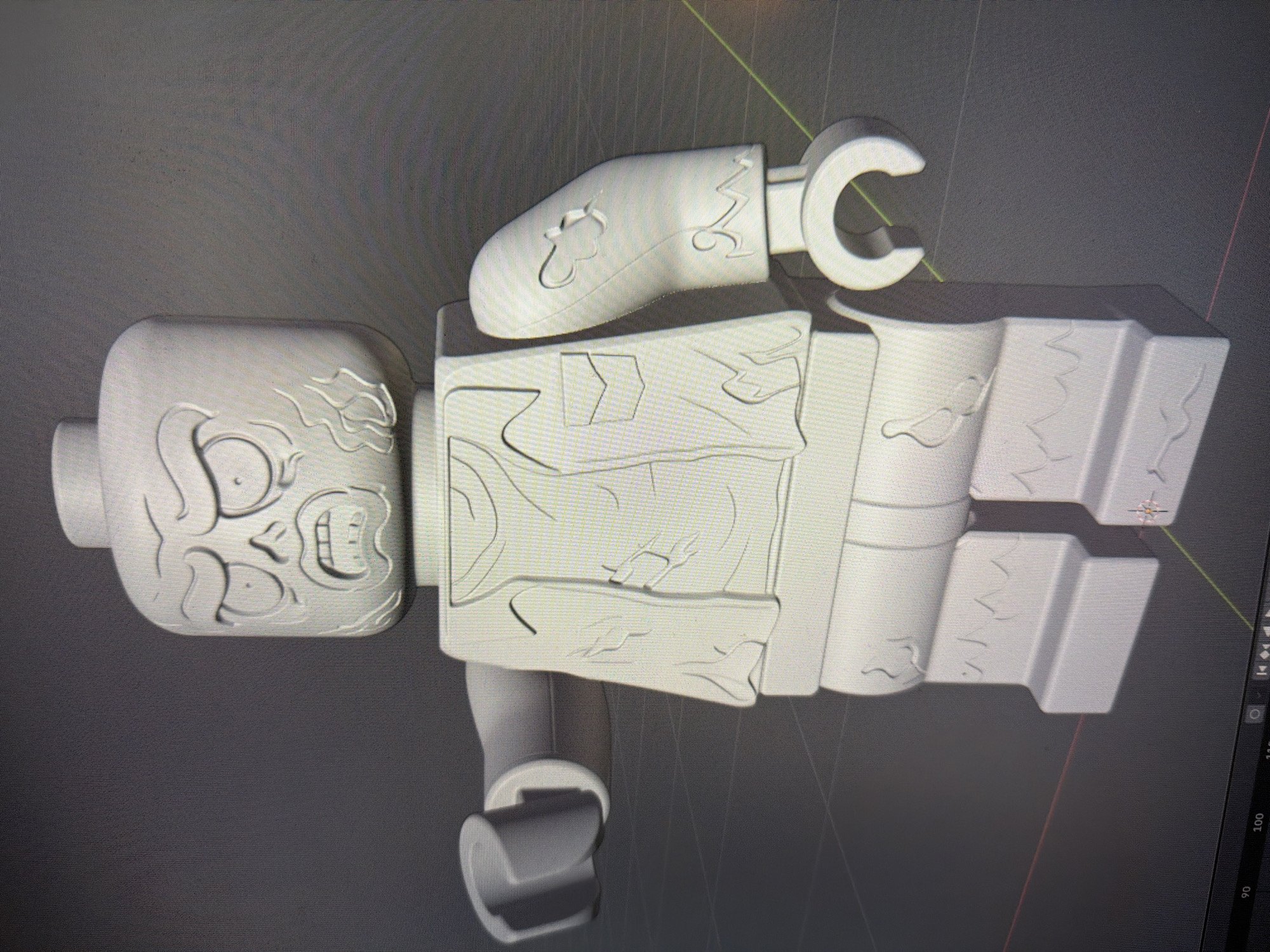 The image displays a 3D rendering of a LEGO-style zombie figure. The figure is rendered in a monochromatic white, suggesting it is a model or sculpture. It features a distressed facial expression with hollow eyes and an open mouth. The body of the figure depicts ripped clothing and what appear to be zombie-like wounds. The background is a plain gray, indicating a digital rendering environment. There is no indication of any specific location in the city of Zvezdara Urban Municipality, Serbia, within the image.
