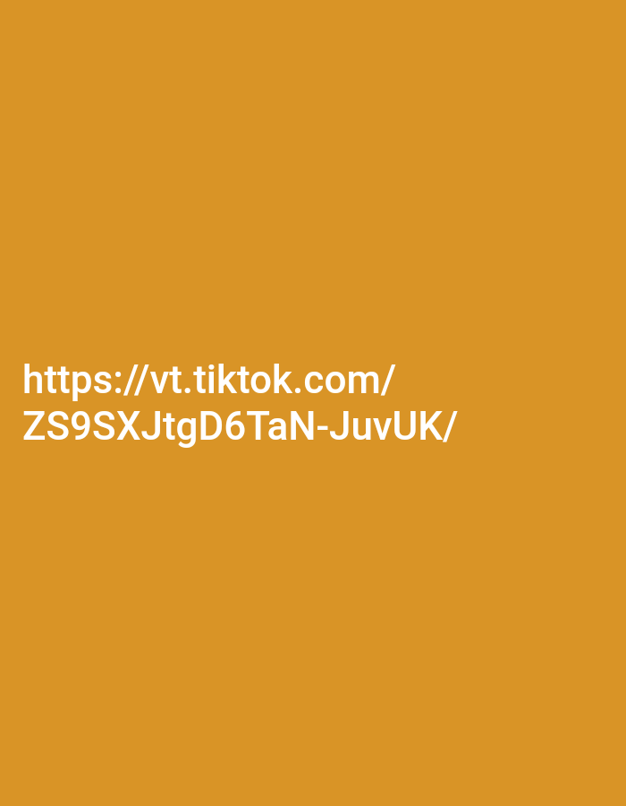 The image displays white text against an orange background. The text reads "https://vt.tiktok.com/" on the first line and "ZS9SXJtgD6TaN-JuvUK/" on the second line. There are no people, subjects, objects, actions, interactions, or environmental details present in the image that would allow for a description of a location in Kendayakan, Indonesia.