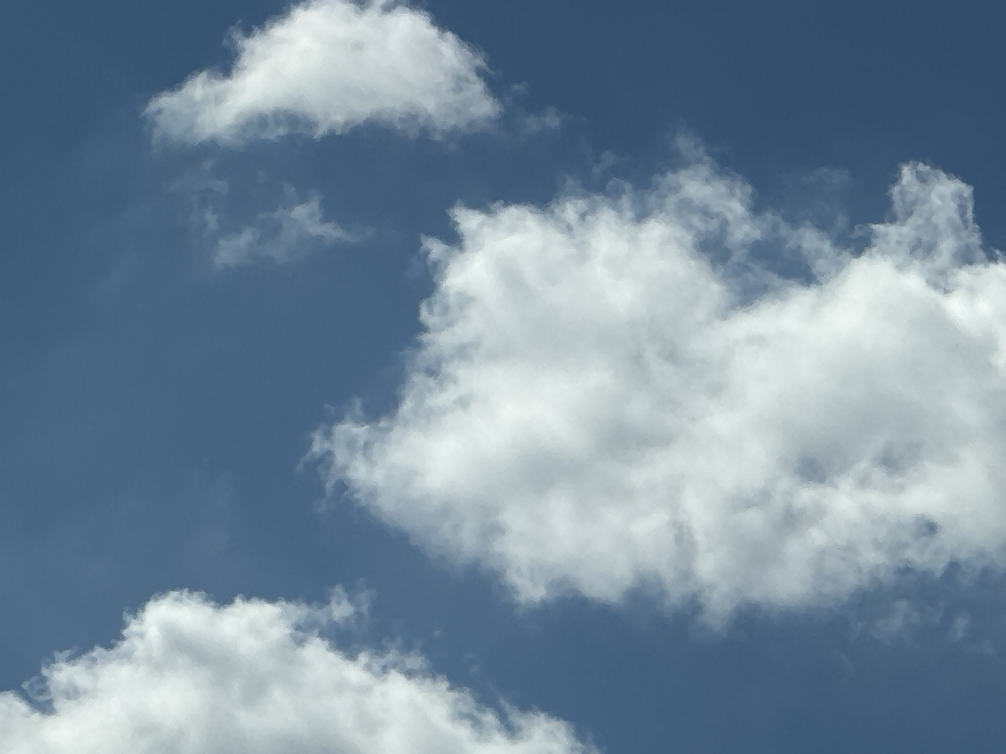 The image depicts a bright blue sky with scattered white cumulus clouds. The clouds are fluffy and appear to be high in the atmosphere. The lighting suggests it is daytime, likely mid-morning or early afternoon. There are no people, animals, or man-made objects visible in the image. The scene is natural and serene. The location of Gamaleevka-1, Russia, is not discernible from the visual content of the image.