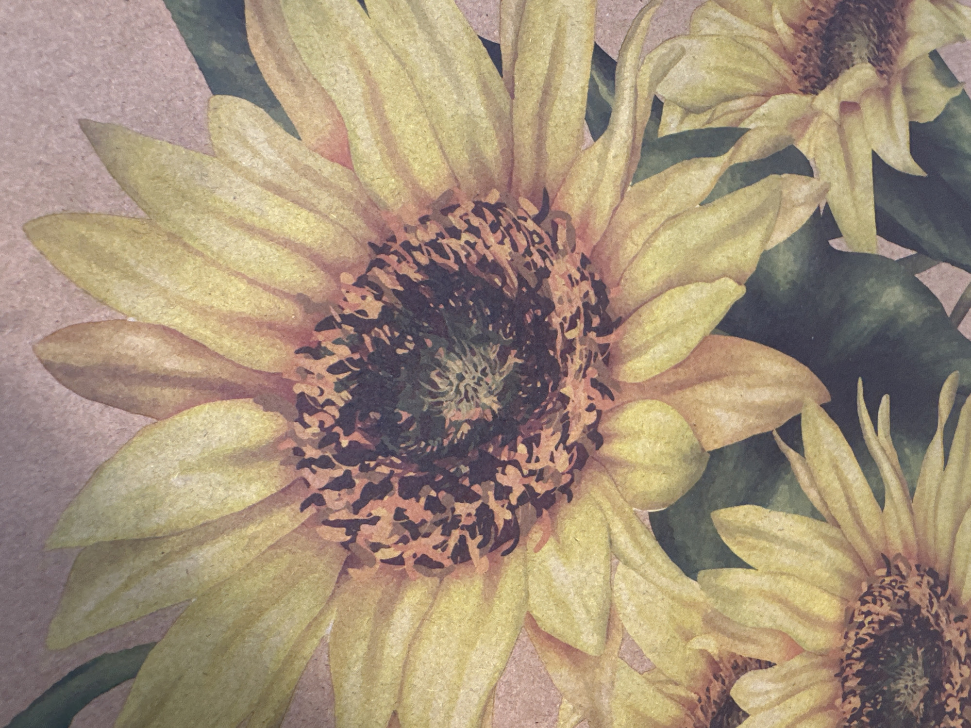 The image is a close-up watercolor painting of sunflowers on a textured, light brown background. The dominant subject is a large sunflower in the center, with vibrant yellow petals and a dark brown and green center. Smaller sunflowers and dark green leaves are visible in the foreground and background, creating a layered effect. The painting style is soft and impressionistic, with visible brushstrokes and variations in color intensity. The image does not depict any specific location in Minsk, Belarus, or any people, actions, or interactions. It is a still life composition of flowers.