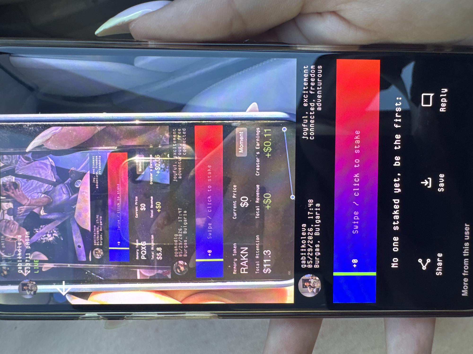 The image depicts a person holding a smartphone displaying a social media interface with a live stream and associated monetization features. The phone screen is reflecting another phone screen, creating a layered image effect. Text overlays on the screen indicate usernames "gabiikoleva", "PATTH", and "ppakodlg". Location details show "Burgas, Bulgaria" with timestamps ranging from 17:41 to 17:48 on 05/29/2026. The interface includes options such as "Share", "Save", and "Reply", along with details about "Memory Tokens" RAKN and PQXG, their values, and potential earnings. Manicured nails are visible holding the phone.