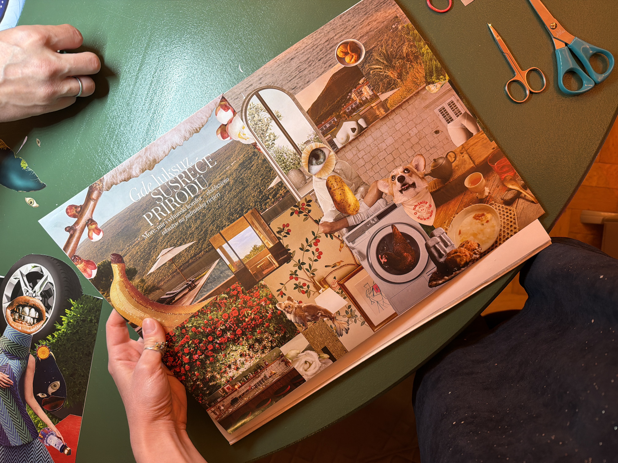 The image depicts a person holding a collage of various images. The collage includes pictures of nature, such as mountains, trees, and the sea, as well as indoor settings with furniture and decorations. There are also surreal elements incorporated into the collage, such as a dog wearing a bandana that says "socially awkward."
A second person is partially visible in the upper-left corner of the image. Scissors and some rubber bands are lying on the green table, indicating that this is likely a craft or art project. The table appears to be a circular, painted surface.
The text on the collage reads "Gde luksuz SUSRECE PRIRODU" which is in Serbian. This roughly translates to "Where Luxury MEETS NATURE." The text indicates the location of the image is in the city of Boreti, Montenegro.