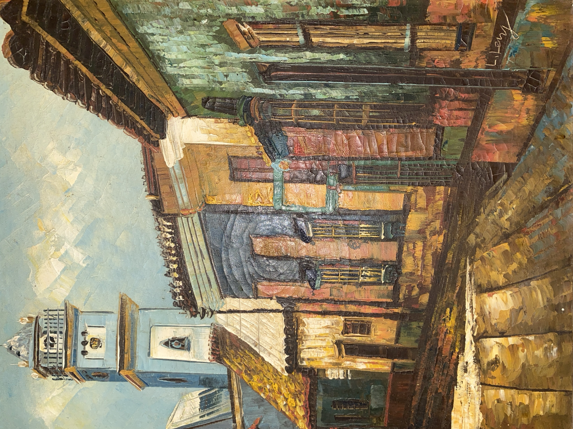 This is a painting of a street scene in Tinaquillo, Venezuela, featuring a prominent blue clock tower. The tower has a light blue facade with gold accents, a square base, and a tiered, ornate top. To the right of the tower are a row of colorful buildings with balconies and arched windows. The buildings display a variety of vibrant hues, including teal, yellow, orange, and pink, with dark roofs. The street in the foreground is paved with cobblestones, rendered in shades of brown and yellow, and appears to be slightly sloped. The sky above is a pale blue with white clouds, painted with visible brushstrokes. The overall style is impressionistic, with thick, textured application of paint. The signature "L. Lery" is visible in the lower right corner of the painting.