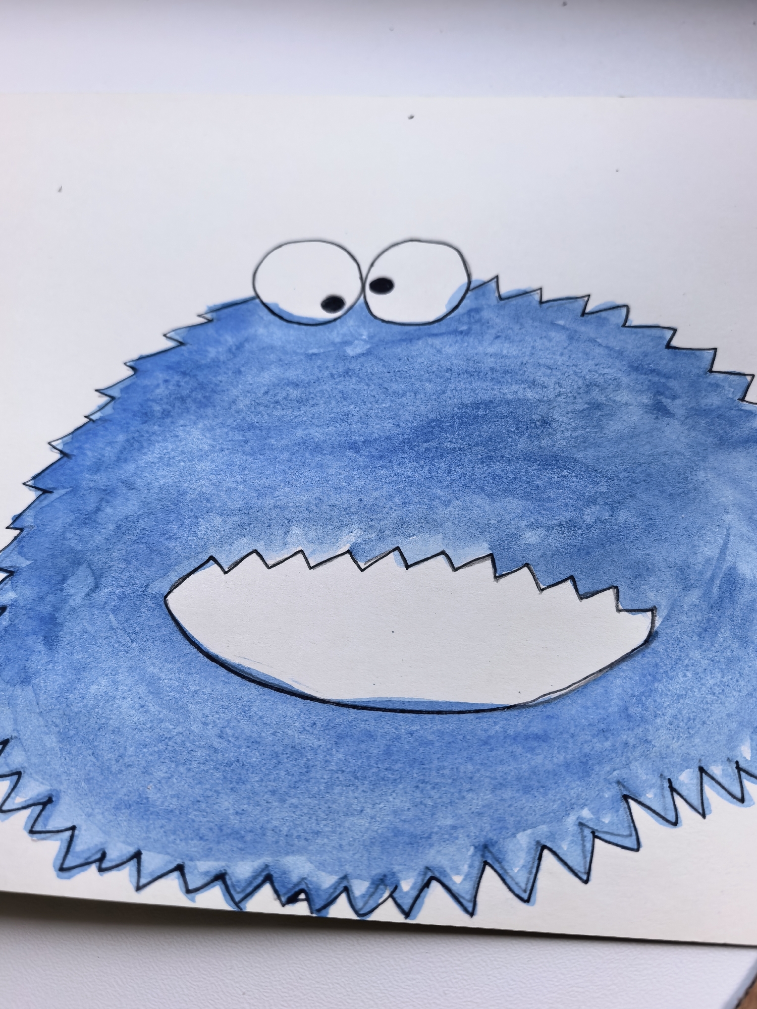 The image shows a watercolor painting of a blue, furry creature with two large, googly eyes and a jagged mouth. The creature appears to be the character Cookie Monster. The painting is on white paper, and the background is plain white. There is no indication of any specific location in the city of Sterlitamak, Russia, or any other city.