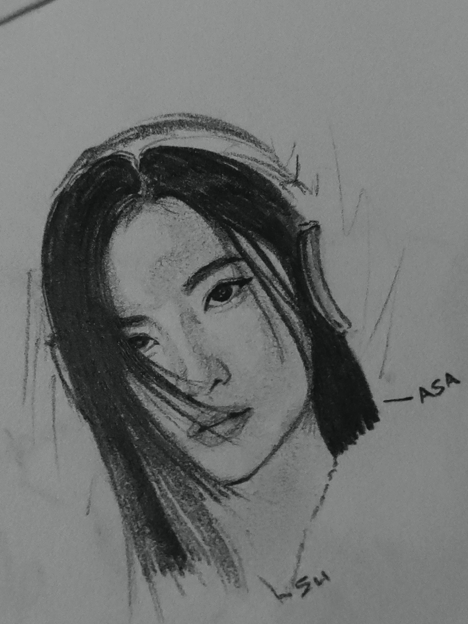 The image displays a grayscale pencil sketch of an individual on a light-colored paper. The drawing depicts a person, likely female, from the chest up, with a slight head tilt and gaze directed downwards and to the viewer's right. The subject has dark, straight hair parted centrally, with some strands sweeping across the right side of the face. They are wearing headphones over both ears. Facial features include almond-shaped eyes, dark eyebrows, a defined nose, and full, slightly parted lips. Shading defines the contours of the face, hair, and headphones. In the lower right area of the drawing, the text "-ASA" is written horizontally. In the lower center-left, the characters "LSU" are visible, oriented vertically and appearing to be a signature. The background is a plain, undetailed surface. The image does not depict any specific geographical location in Davao City or elsewhere.