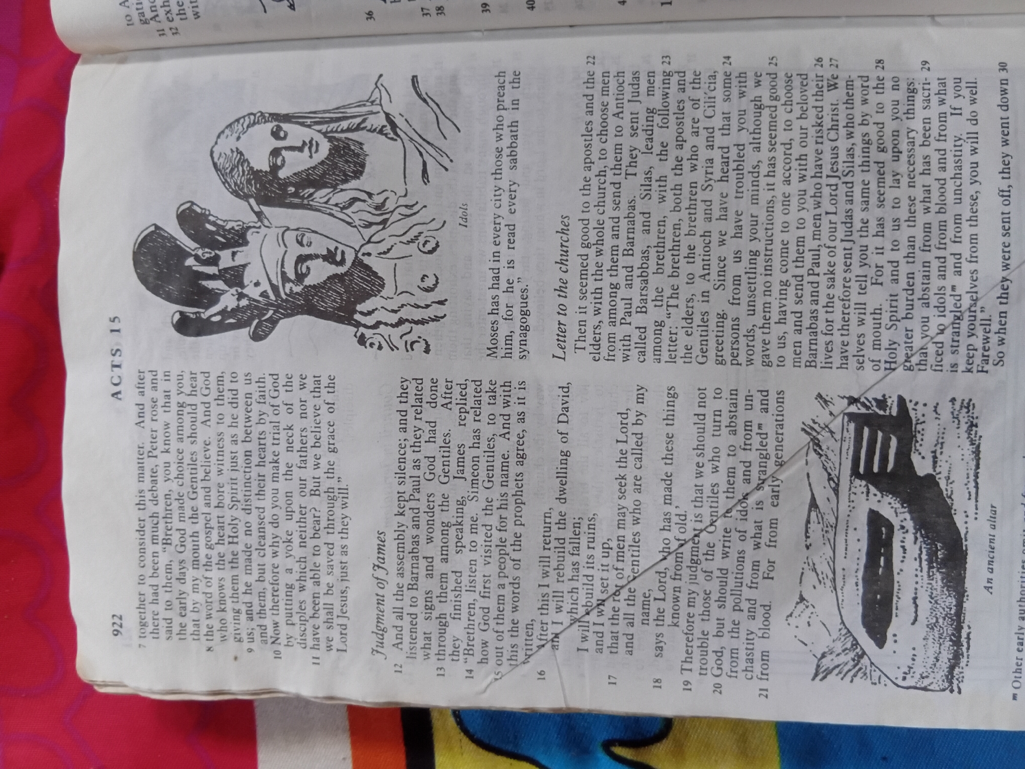 The image displays an open book, likely a Bible, with text and illustrations. The page is predominantly white, with black text and black and white illustrations.
The illustrations on the left depict stylized human faces, possibly religious figures, in a simple, linear style. One illustration is of an altar, described by accompanying text as "An ancient altar".
The text is predominantly in English, with chapter and verse numbers clearly visible, such as "ACTS 15" and verse numbers like "7", "8", "9", etc. There are also headings like "Judgment of James" and "Letter to the churches". Some words are marked with a superscript "m", such as "strangled™".
The context provided states the location as Nkpor, Nigeria, which is relevant to the religious nature of the content, suggesting this is a page from a Bible being used in that location. The overall impression is one of study or reading of religious text. No specific time of day, weather, or strong emotions are discernible from the static image.