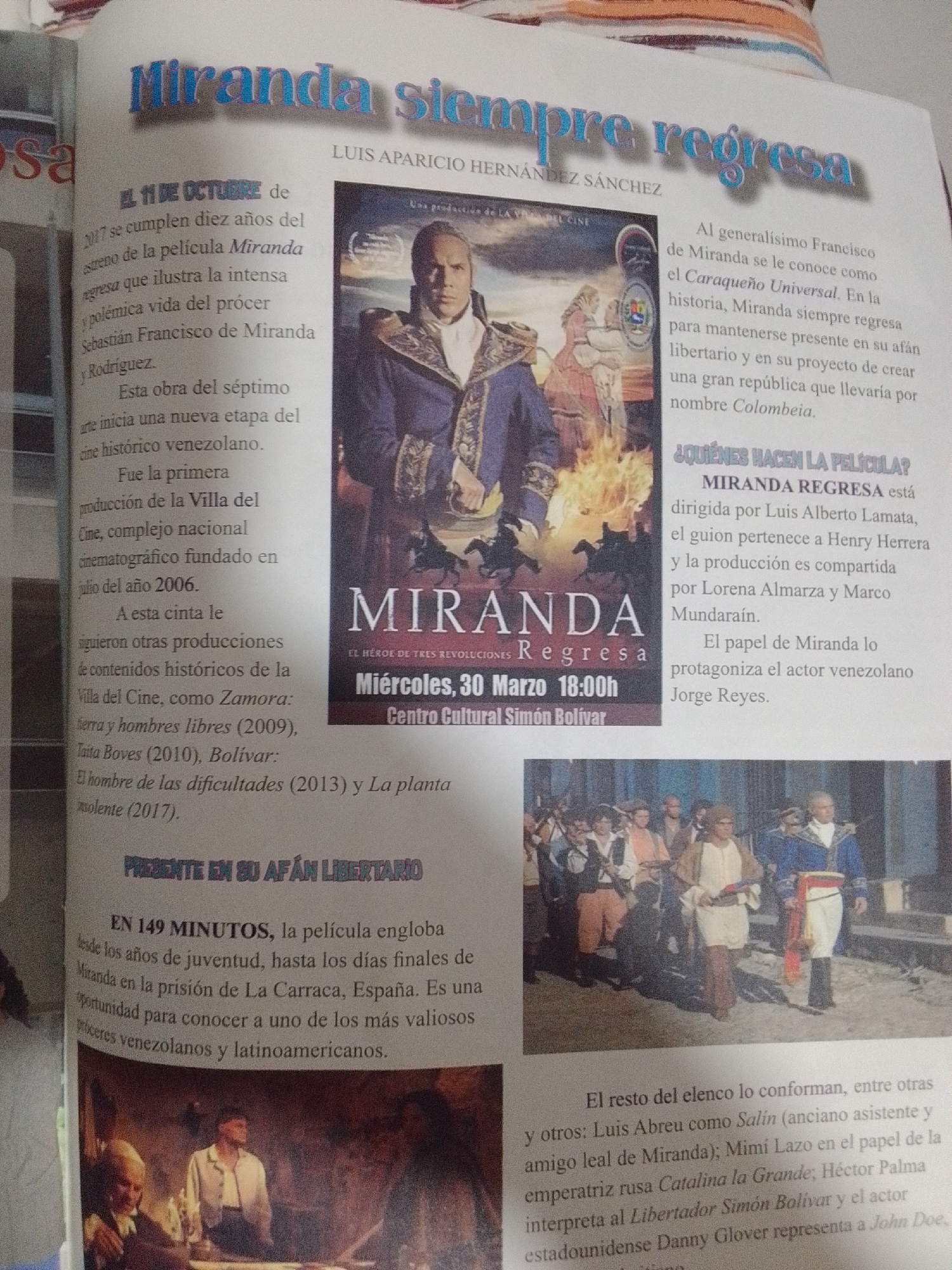 The image is a scanned page from a magazine or newspaper, featuring articles and photographs related to the Venezuelan film "Miranda Siempre Regresa." The top portion of the page has a large headline in blue and silver lettering that reads "Miranda Siempre Regresa." Below this headline is text mentioning Luis Aparicio Hernández Sánchez.
The main visual element is a poster for the film "Miranda," which depicts a man in historical attire, possibly Francisco de Miranda, with flames in the background. The poster also lists the film's title, "EL HÉROE DE TRES REVOLUCIONES," and details about its screening: "Miércoles, 30 Marzo 18:00h" and "Centro Cultural Simón Bolívar."
To the left of the poster, there is text discussing the film's release, its historical context, and other related productions from "Villa del Cine." To the right of the poster, there is a section titled "¿QUIÉNES HACEN LA PELÍCULA?" which details the director, scriptwriter, producers, and the actor playing Miranda.
Below the poster is a photograph of a group of people in historical costumes, appearing to be actors from the film. In the lower right corner, there is another block of text describing the rest of the cast.
The image also includes smaller text snippets that appear to be captions or related articles. One snippet, located in the lower left, mentions "PRESENTE EN SU AFÁN LIBERTARIO" and describes the film's scope, from youth to the final days of Miranda in prison in La Carraca, Spain. However, there is no mention of the city of La Tagua, Venezuela, in any of the visible text.