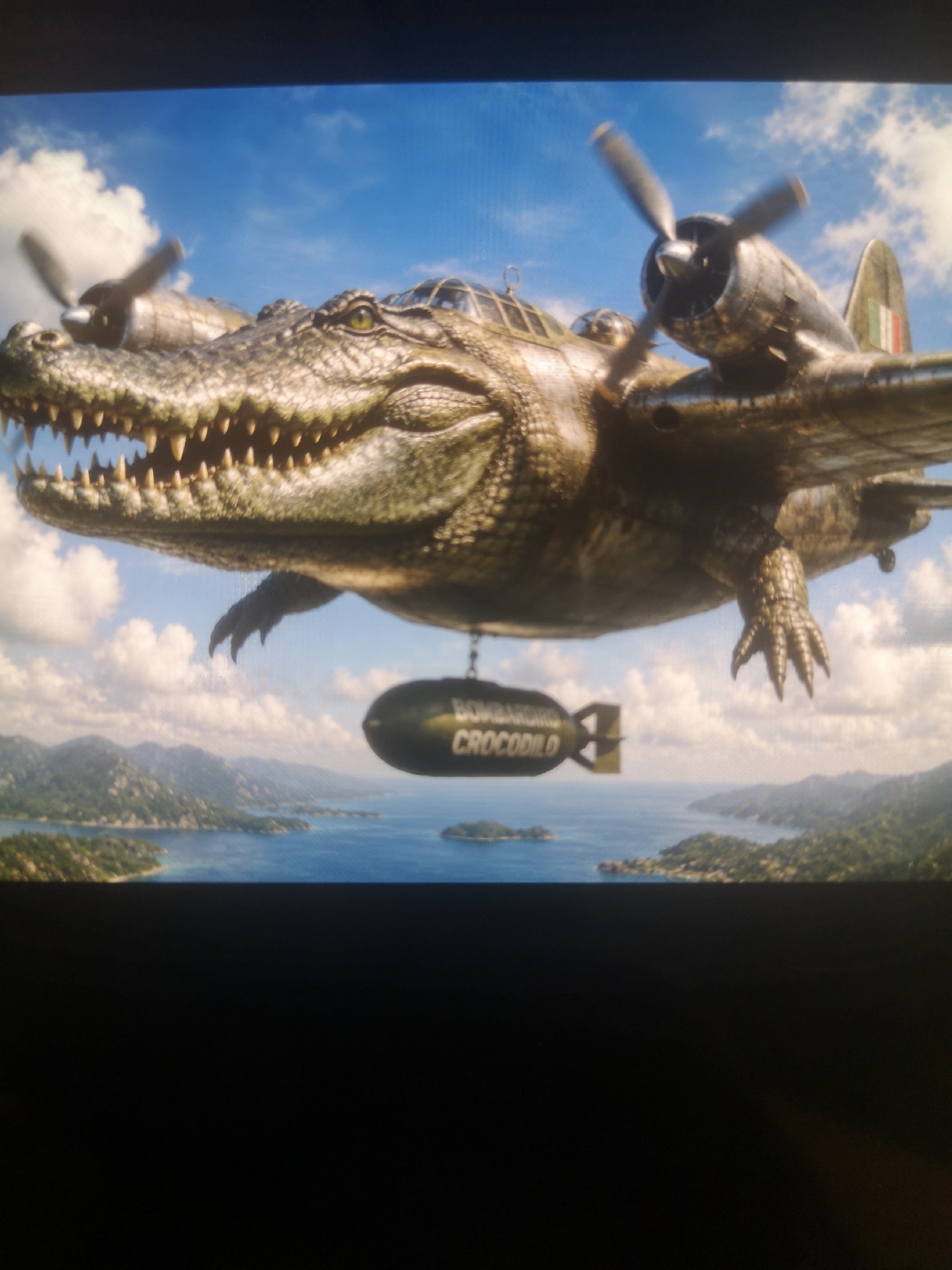 A surreal image shows an alligator-shaped airplane flying over a body of water dotted with islands. The plane has two propellers and a "Bombardilo Crocodilo" bomb hanging beneath it. The sky is blue with scattered clouds. The location is not known, and there is no city visible. There are no people in the scene.