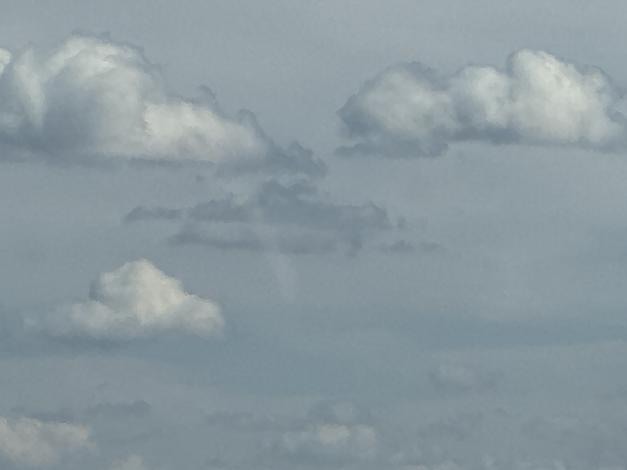 The image shows a sky filled with clouds. The clouds are white and fluffy, with some areas of darker gray indicating shadow. The sky is a pale blue. The image appears to be a photograph taken from below, looking up at the clouds. There is no indication of the city of Gamaleevka-1, Russia, or any people, subjects, objects, or actions within the image.
