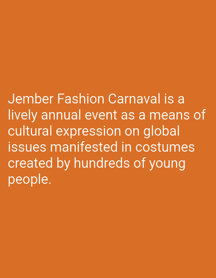 The image is a solid orange background with white text. The text describes the Jember Fashion Carnaval, an annual event in Jember, Indonesia. It states that the event is a lively annual event as a means of cultural expression on global issues manifested in costumes created by hundreds of young people. The coordinates provided, -7.774 latitude and 114.139 longitude, place the location in Arjasa, Indonesia. There are no people, subjects, objects, actions, interactions, or environment depicted in the image.