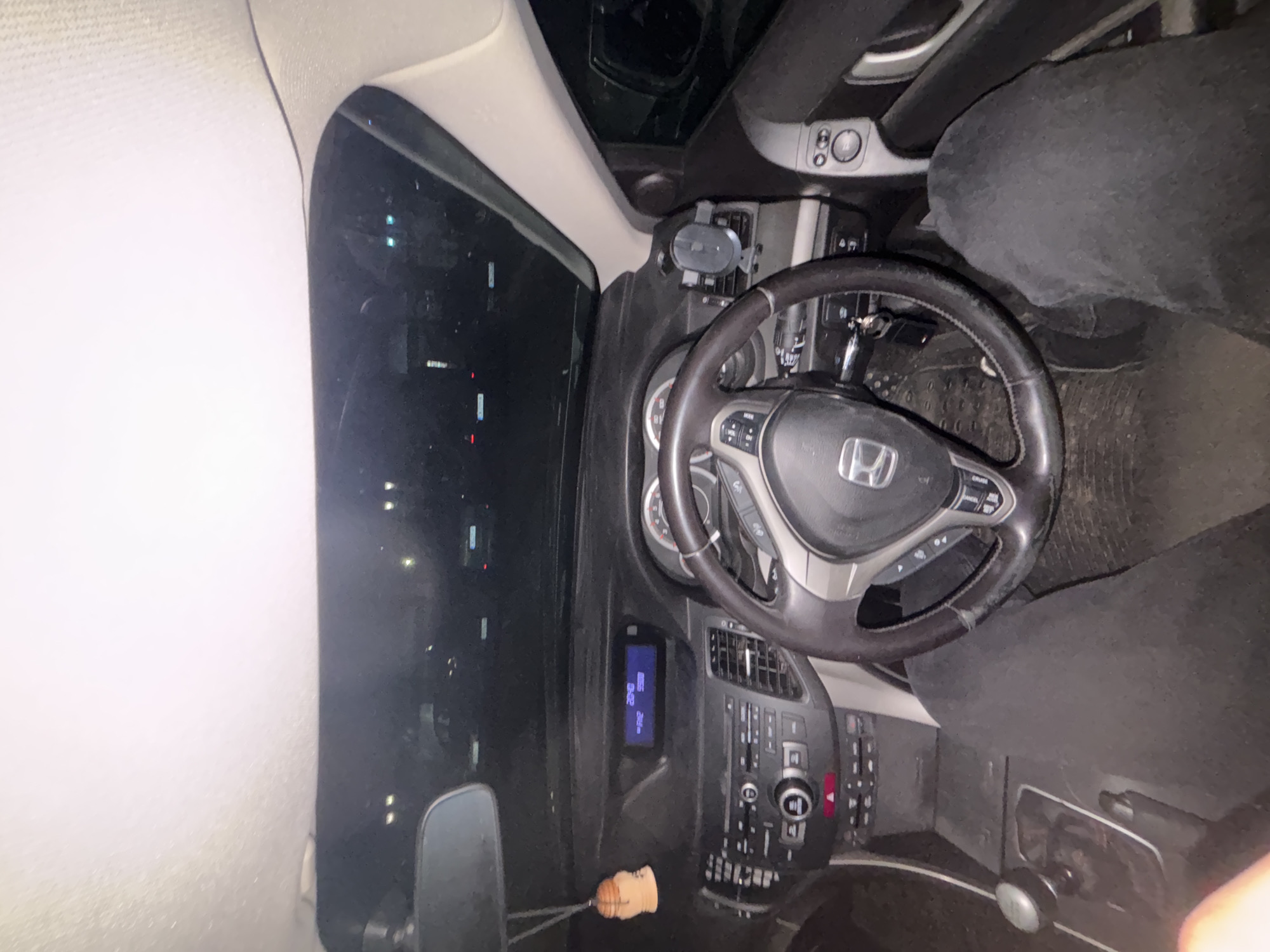 The image shows the interior of a Honda car, specifically the dashboard, steering wheel, and driver's seat. The time on the dashboard is 20:48. A car air freshener is hanging below the dashboard. The location cannot be determined to be in Zlatograd, Bulgaria, from the contents of this image.