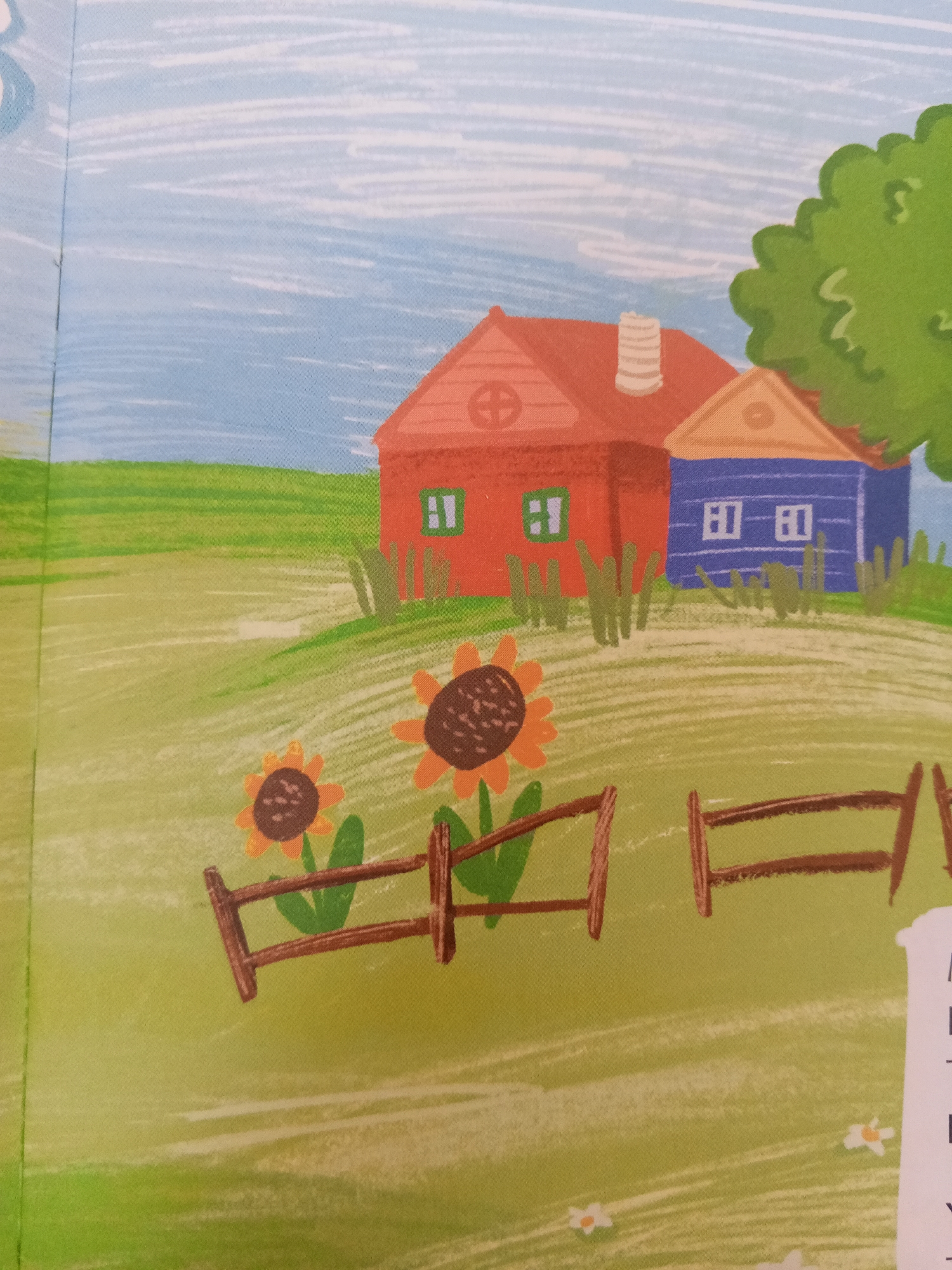 The image is an illustration depicting a rural scene with two houses, a fence, sunflowers, and a tree. One house is red with a white-striped chimney and a circular window. The other house is blue with two rectangular windows. The houses are situated on a green, hilly landscape. In the foreground, a wooden fence separates two sunflowers from the houses. The sky is light blue with white, horizontal strokes. There is no indication of the city of Chistopol, Russia.