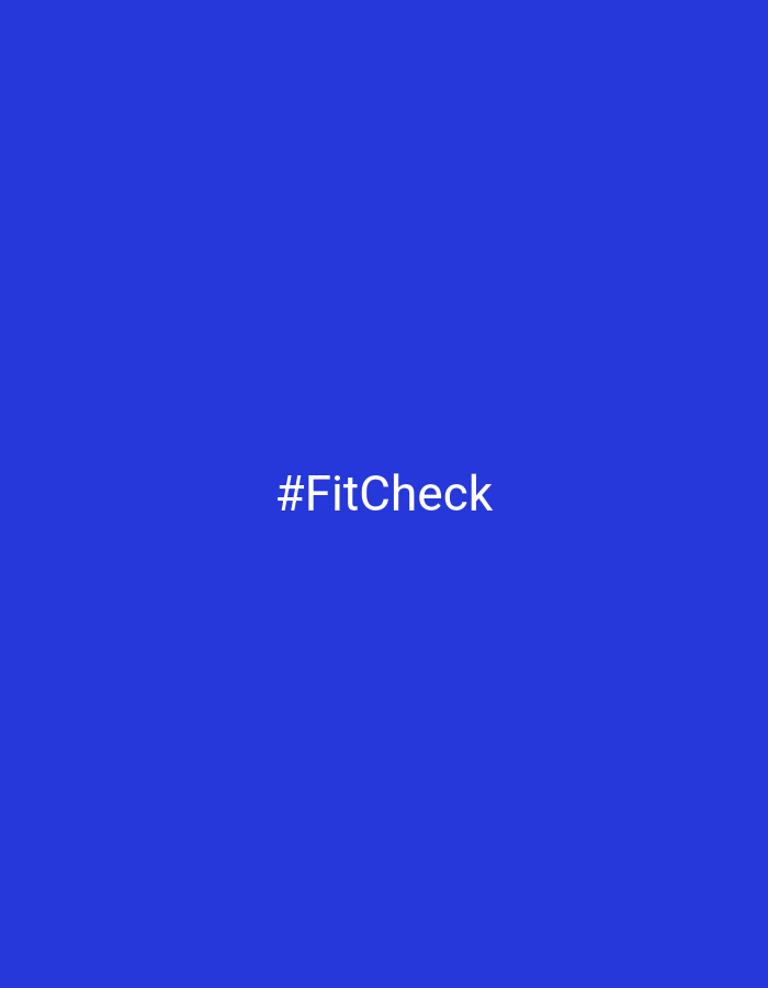 The image displays a solid blue background. Centered on this blue canvas is the text "#FitCheck" rendered in white, sans-serif letters. There are no other subjects, objects, or activities depicted in the frame. The image is minimalist, focusing solely on the text against the colored backdrop. No discernible elements indicate a specific time of day, weather conditions, or geographical location within the image itself, despite the provided context of Chaikovsky, Russia.