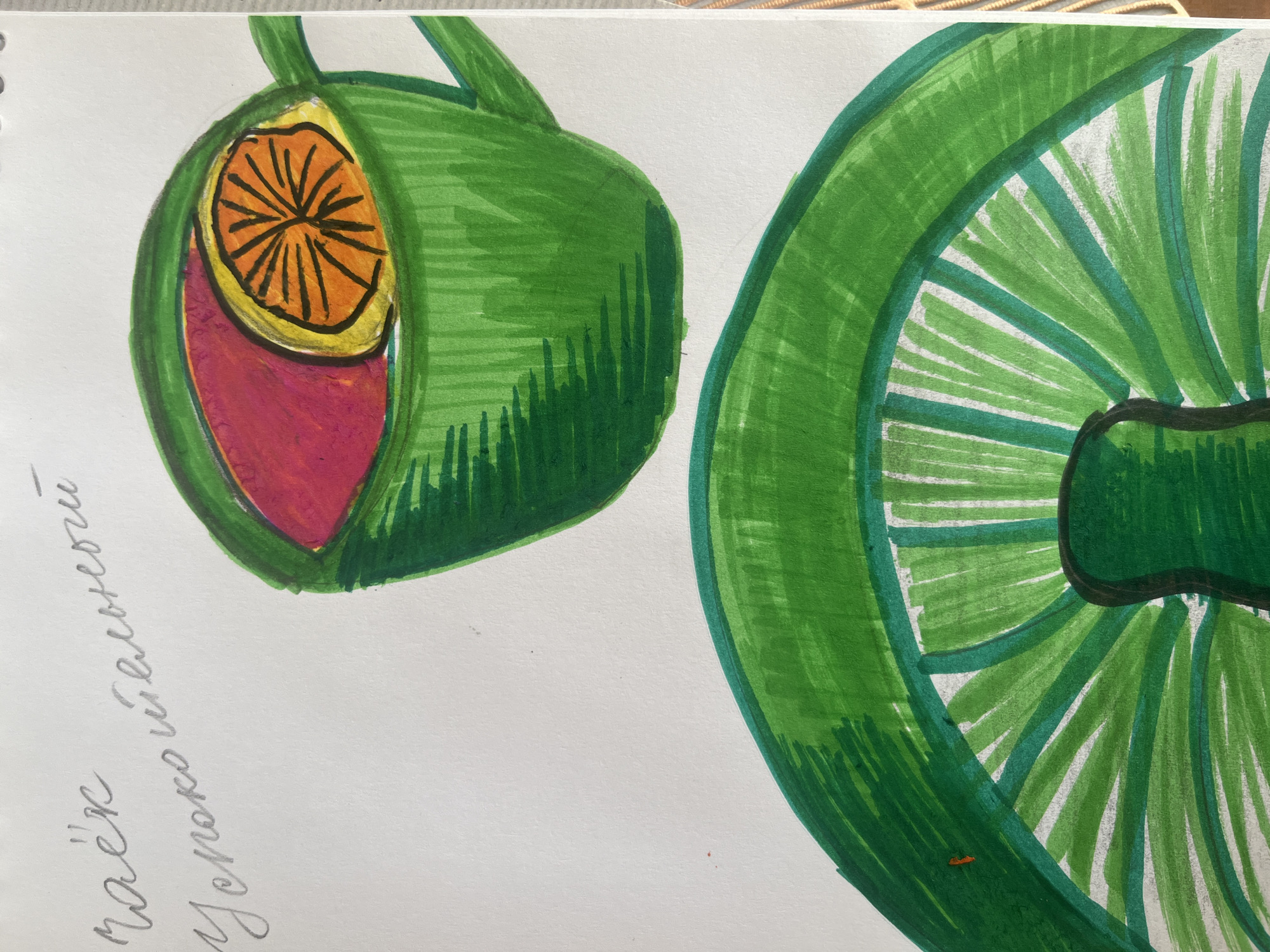 The image is a drawing on a piece of paper, likely a page from a sketchbook, depicting a green cup with a slice of orange and red liquid, presumably tea, and a large green object in the foreground. The drawing is done with markers, with visible brush strokes. In the upper left corner of the paper, there is handwritten text in Russian. The text reads "Чай успокоительный" which translates to "Calming tea". There are no identifiable landmarks or specific environmental features that would indicate a location in the city of Kyiv, Ukraine. The focus is solely on the artistic rendering of the tea and the abstract green shape.