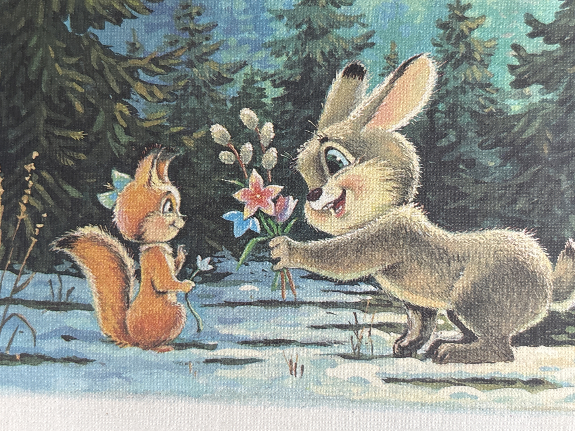 An illustration depicts two anthropomorphic animals in a forest setting. A squirrel, with orange fur and a bushy tail, is perched on a branch, wearing a blue bow on its head. Below it, a rabbit, with light brown fur, is hanging from a branch, holding a bouquet of flowers and willow catkins. The background features a blue sky with some dark green foliage, suggesting a natural, outdoor environment. The scene appears to be part of a children's book or story. The image does not contain any information about the city of Январцев ауылдық округі, Kazakhstan.