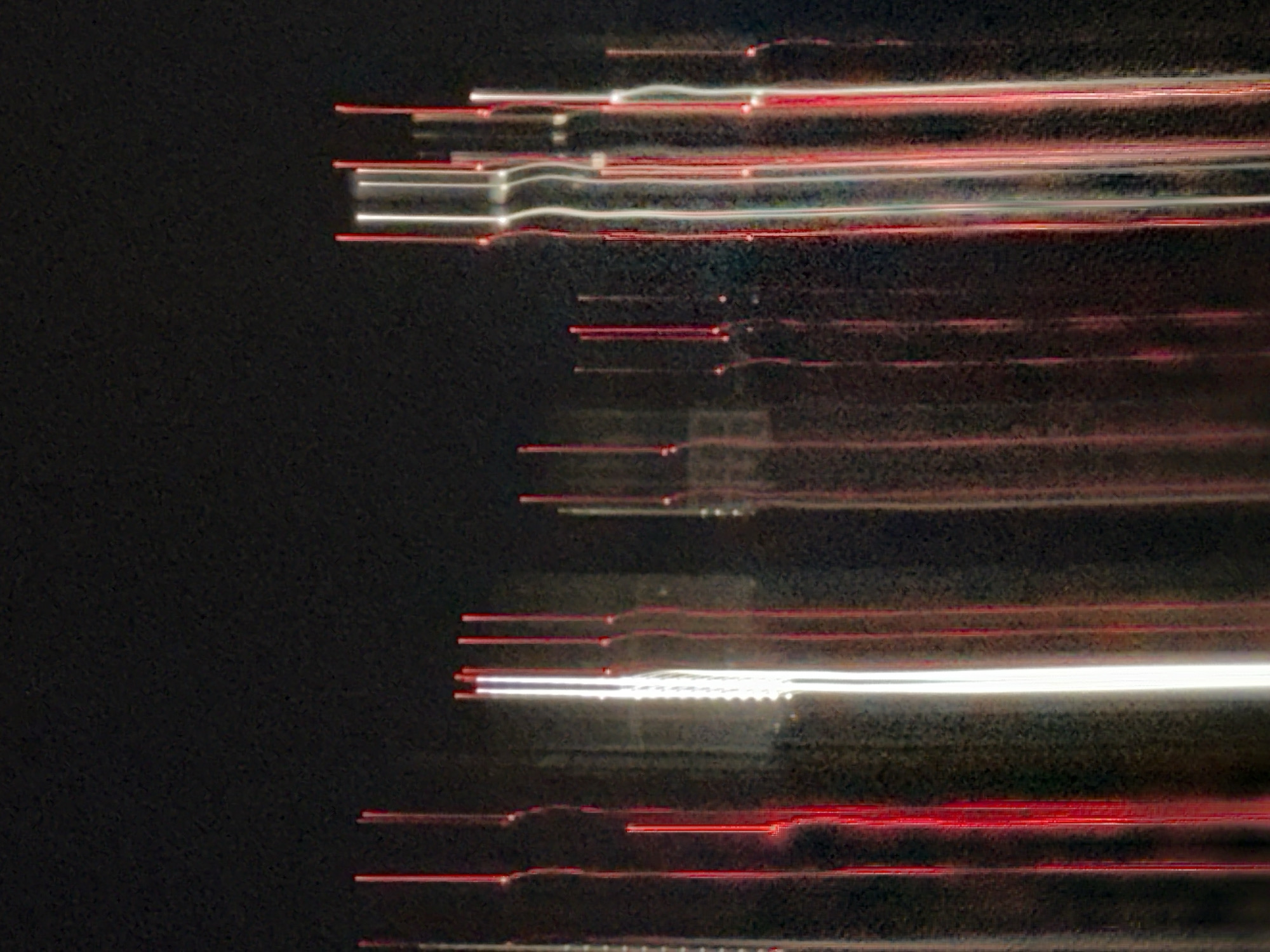 The image shows light streaks against a dark background. The streaks are predominantly red and white, suggesting long-exposure photography capturing the movement of light sources. There is insufficient detail to definitively state the location as Nizhny Novgorod, Russia.
