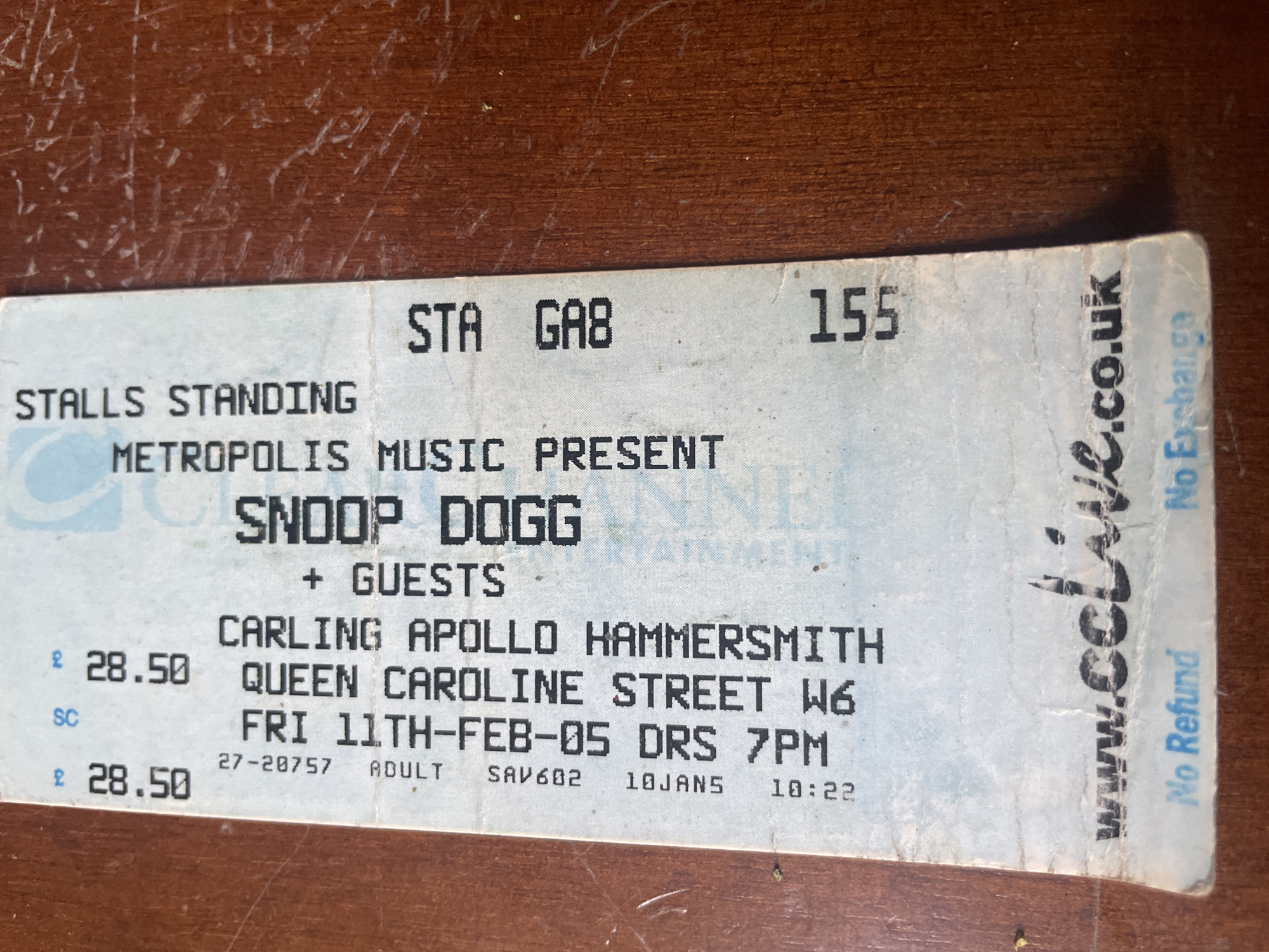 The image shows a ticket stub for a Snoop Dogg concert presented by Metropolis Music. The concert was held at the Carling Apollo Hammersmith, located on Queen Caroline Street W6. The concert took place on Friday, February 11, 2005, with doors opening at 7 PM. The ticket price was £28.50. The ticket is for stalls standing in section GA8, number 155. The ticket includes the website "www.colive.co.uk" and states "No Refund, No Exchange". The ticket also has codes "27-20757", "SAV602", "10JAN5", and "10:22".