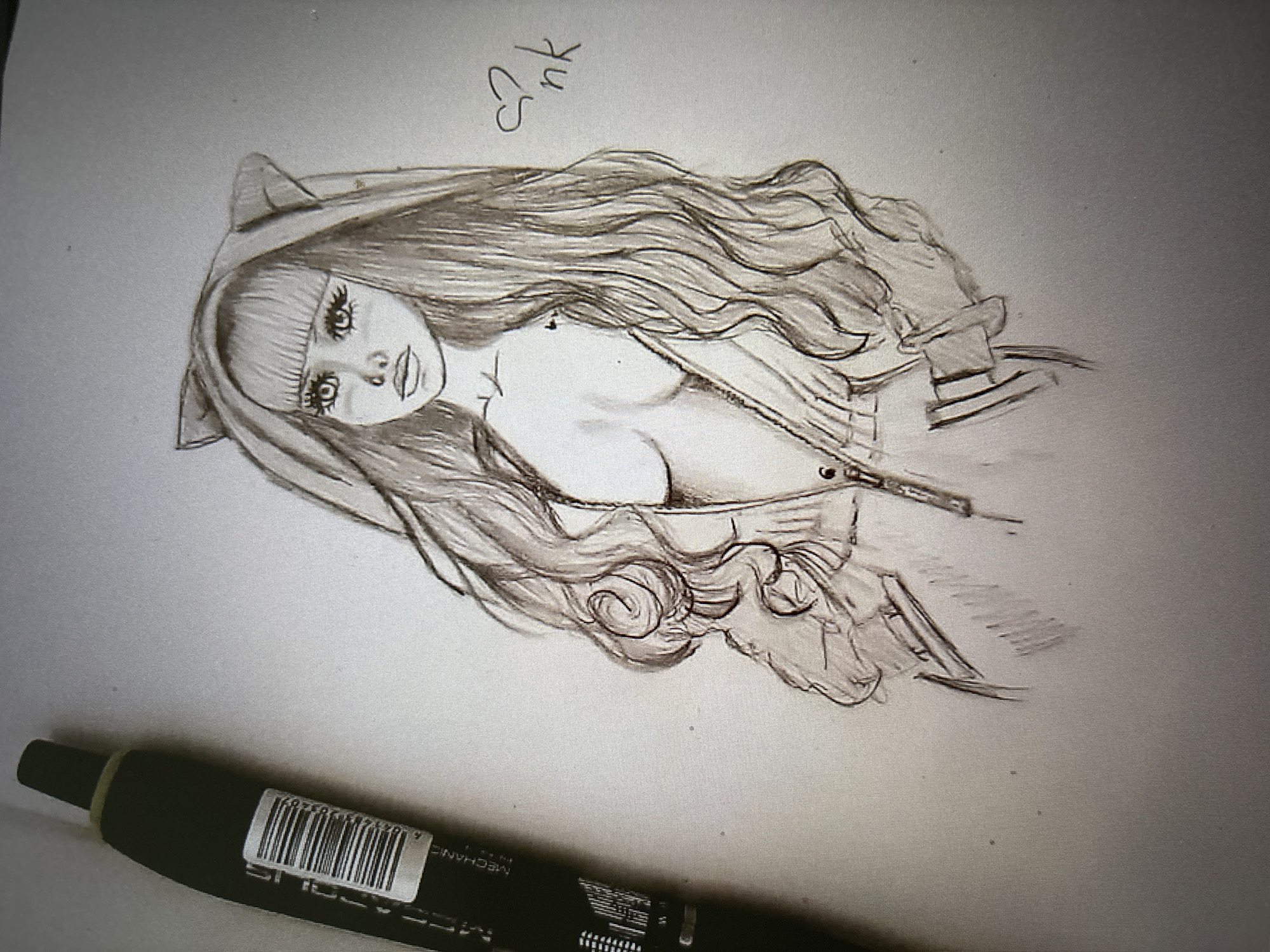 A graphite sketch depicts a young woman with long, wavy hair and cat ears on a hooded jacket. She is wearing the unzipped jacket, revealing her décolletage. Her eyes are large and detailed, with prominent eyelashes. In the upper right corner of the sketch, there is a small drawing of a heart and the letters "nk". To the left of the sketch, a portion of a black marker with a barcode is visible. The background is plain white. The image does not contain any information about the city of Novosibirsk, Russia.