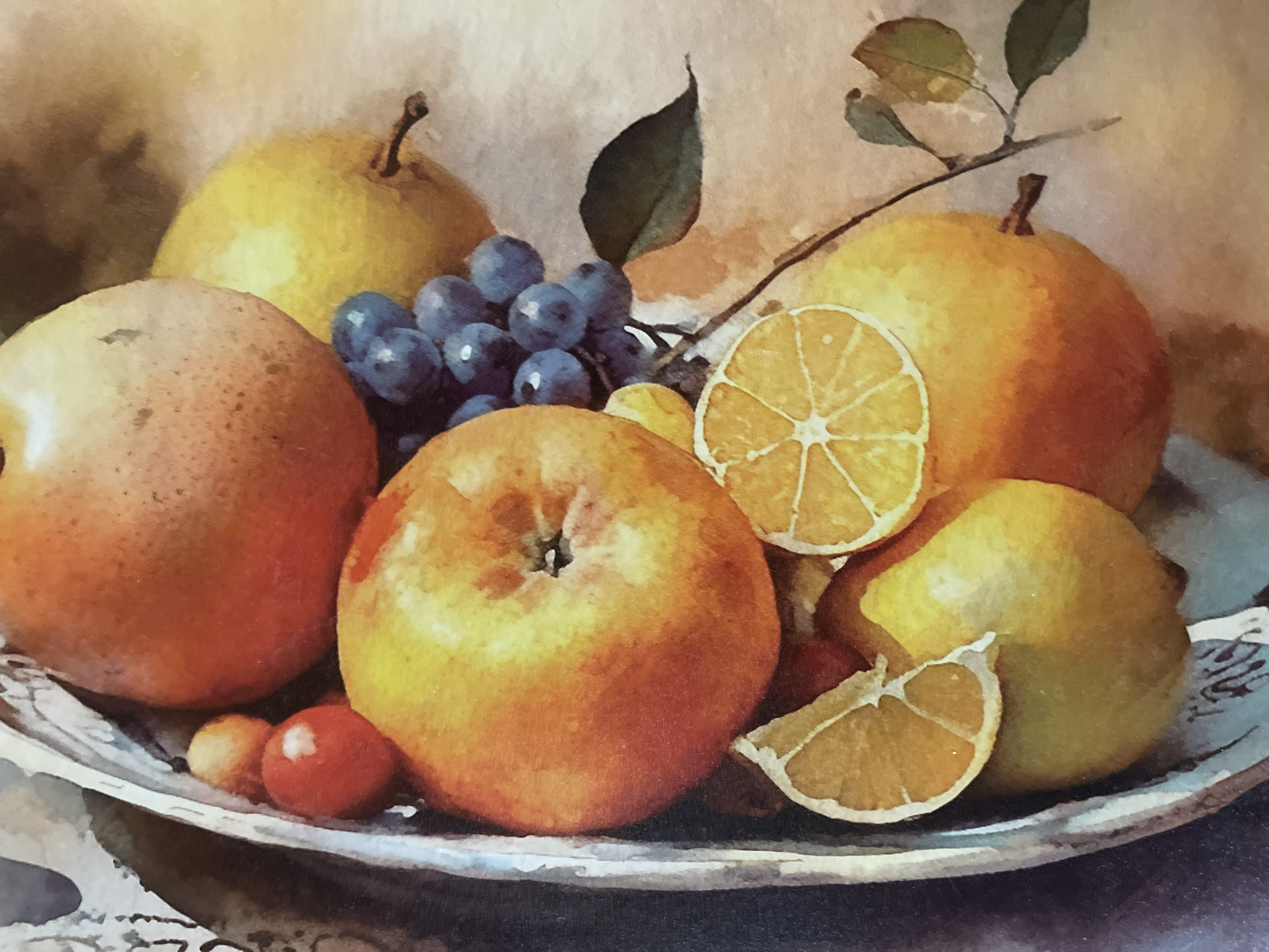 This is a still life painting of a fruit arrangement. The arrangement includes several round fruits, possibly apples and pears, in shades of orange, yellow, and reddish-brown. There are also a cluster of dark blue grapes and slices of what appear to be oranges or lemons, characterized by their segmented interiors and rind. The fruits are presented in a shallow, ornate bowl with a textured, possibly silver or metallic, rim that has decorative elements. A branch with a few green leaves extends from the right side of the arrangement. The overall style suggests a classical or traditional approach to still life, with soft lighting and a focus on the texture and color of the fruits. The background is muted and appears to be a flat, light-colored surface. There is no indication of any specific location in the city of Minsk, Belarus, or any people, actions, or interactions.