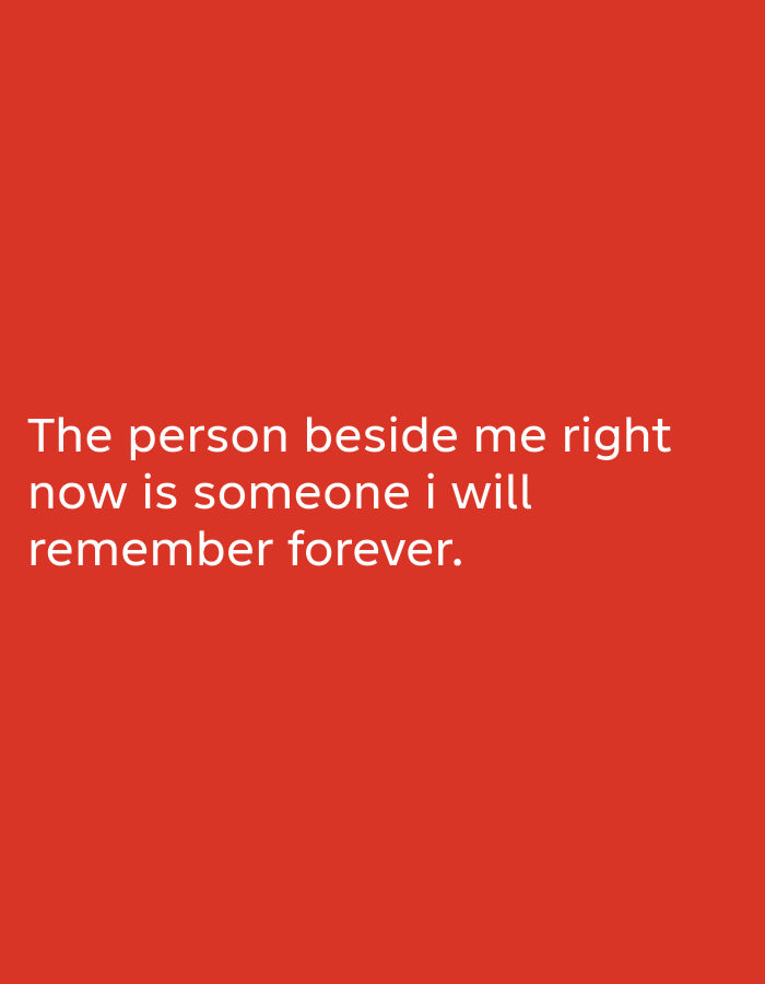 The image is a photograph of text overlaid on a solid red background. The text, in white sans-serif font, reads: "The person beside me right now is someone i will remember forever." The image does not depict any discernible location within South Jakarta, Indonesia, or any specific people, subjects, objects, actions, or interactions. It is a purely typographic image against a plain background.