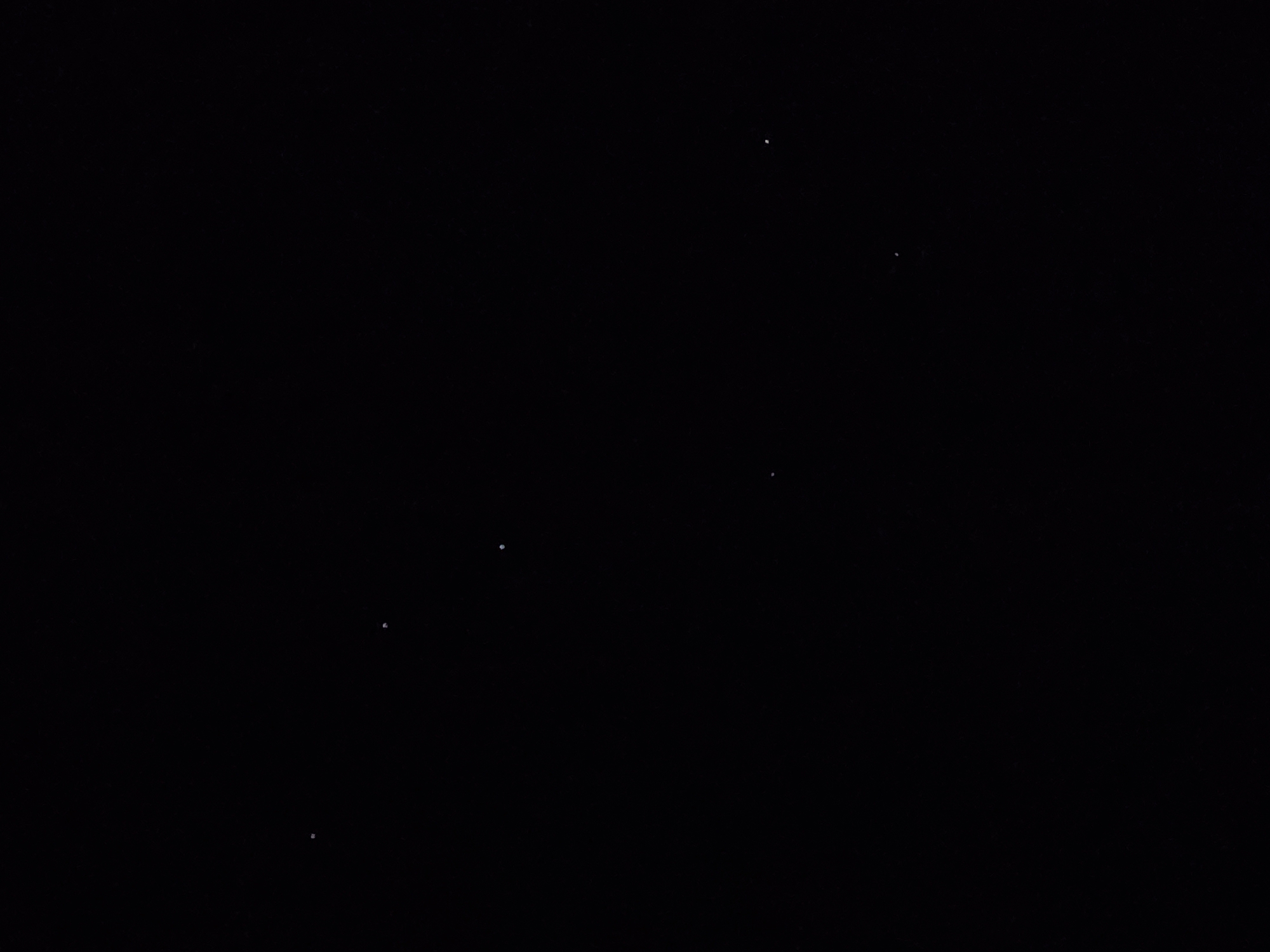 This media file presents a predominantly black, dark, and underexposed image. The primary subjects are several small, scattered bright white dots against a uniformly deep black background.
There are no discernible people, objects, or a clear scene beyond these luminous points. The environment appears to be either a vast, dark expanse, such as a night sky with a few visible stars, or an extremely dark indoor setting where these white dots could be reflections, dust particles catching light, or digital noise. The low number and irregular distribution of the white dots might suggest a partially cloudy night sky or a very distant view of a few bright celestial objects, rather than a dense starfield.
No specific activity or event is taking place; the image is static.
Notable details include:
- **Time of day:** Strongly implied to be nighttime if depicting an outdoor scene, or a very dark indoor environment.
- **Weather:** Not ascertainable, but if it's a night sky, it would imply clear conditions for any stars to be visible, however few.
- **Location cues:** There are no explicit geographical or environmental cues. The composition offers no horizon, land, or architectural features.
- **Emotions:** The image does not convey any specific emotions.
- **Visible text:** There is no visible text in the image.
The overall impression is one of stark minimalism and ambiguity, characterized by the contrast between the intense darkness and the few isolated points of light.