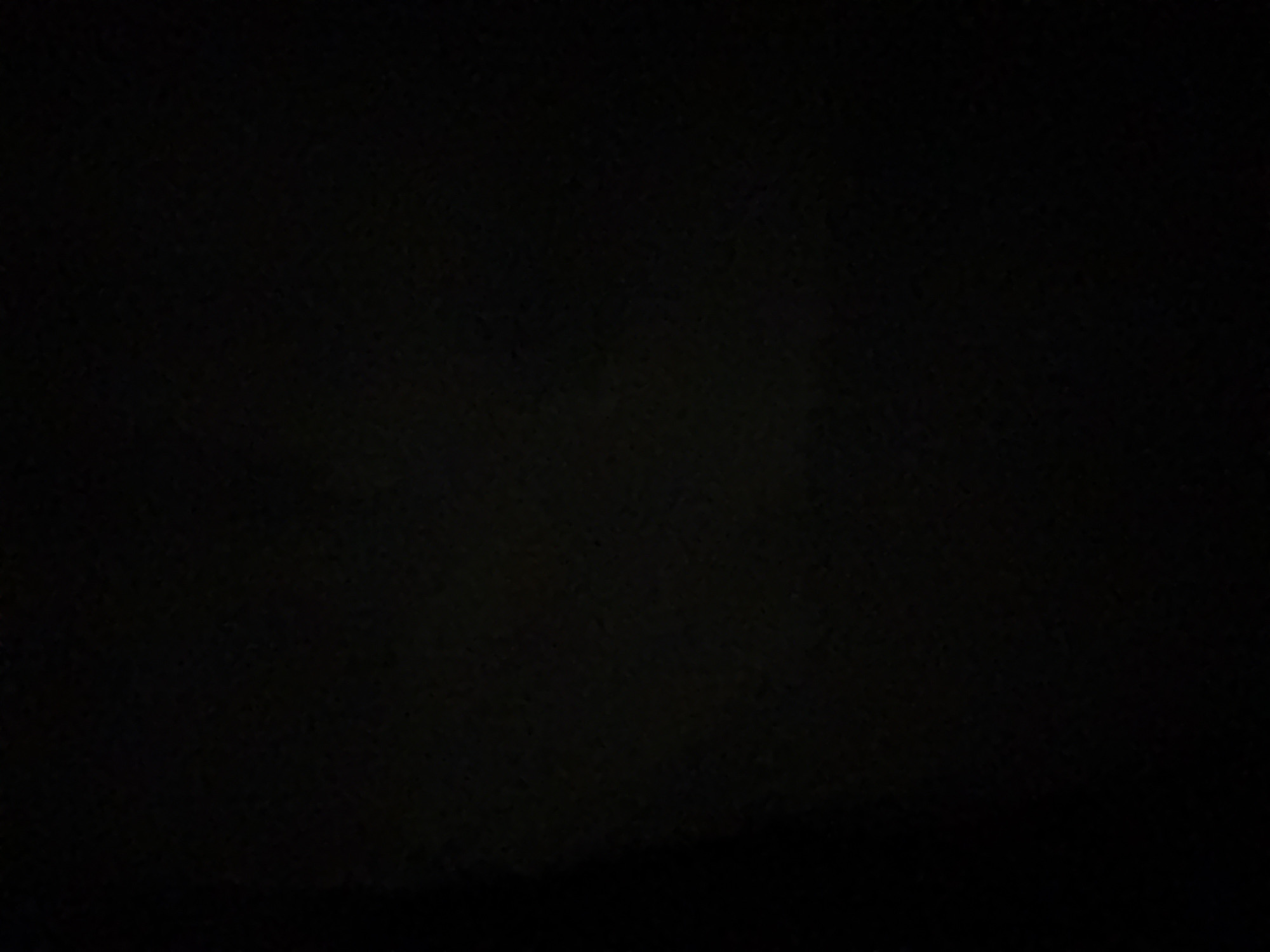 The image is entirely black and shows no discernible objects, people, or environmental details. Therefore, it is not possible to provide a description of a scene in the city of Doma 1096 Km, Russia, or any other location, based on this image.