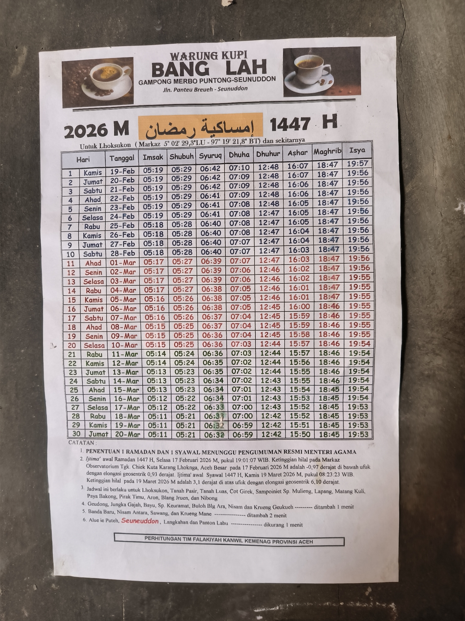 This image shows a printed schedule for prayer times during Ramadan in 2026 M (1447 H), for Lhoksukon, Indonesia and surrounding areas, with an advertisement for a local coffee shop ("Warung Kupi Bang Lah") located in Gampong Merbo Puntong-Seunuddon. The schedule includes dates, days of the week, and times for Imsak, Shubuh, Syuruq, Dhuha, Dhuhur, Ashar, Maghrib, and Isya prayers. Below the schedule are notes regarding the determination of Ramadan and Syawal, and time adjustments for specific areas near Lhoksukon. The bottom of the image states the schedule was calculated by the Falakiyah Team of the Ministry of Religious Affairs of Aceh Province. Above the schedule is a picture of a cup of coffee.