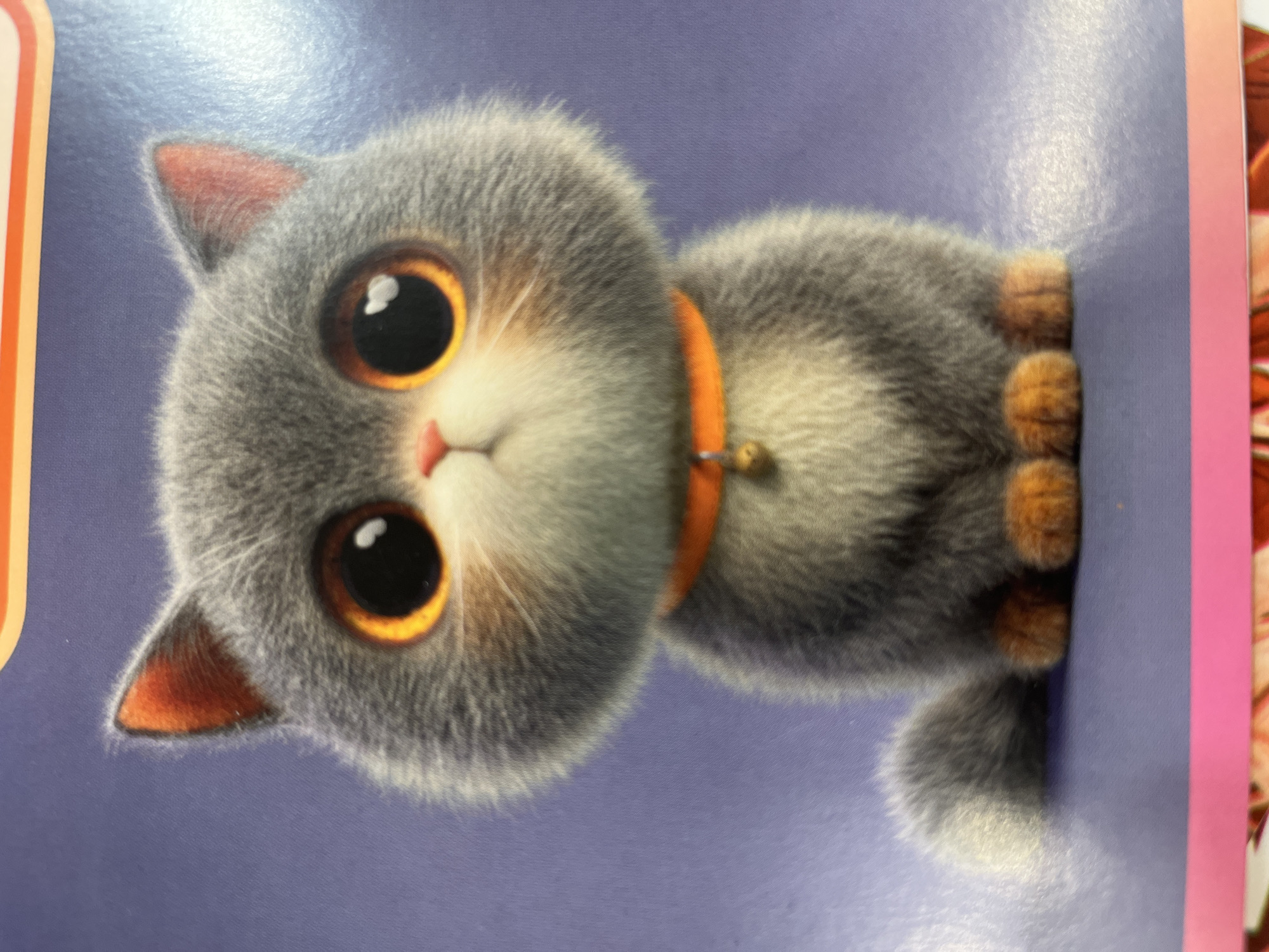 The image is a close-up, posed, digital illustration of a stylized cartoon cat sitting upright. The cat is predominantly gray with white and orange accents. It has large, round, orange eyes with black pupils and white reflections, a small pink nose, and prominent whiskers. The cat is wearing a bright orange collar with a small, golden bell attached. Its paws are a reddish-orange color. The background is a solid, muted purple color. The image is well-lit, with no shadows visible, suggesting it is not a photograph of a real-world scene. The context of the city of Kharkiv, Ukraine is not depicted or suggested in this image.