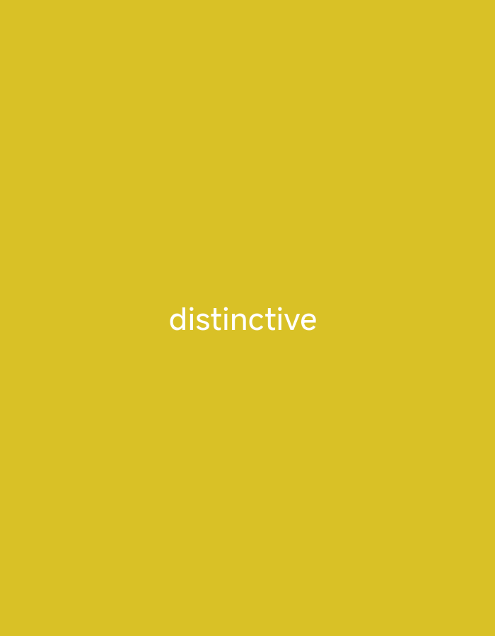 The media file is a simple, minimalist image with a solid, mustard-yellow background. Centered on the background, in white text, is the word "distinctive". There are no people, objects, or discernible scenes present. The image does not provide any information about the time of day, weather, or location. The only notable detail is the text itself.