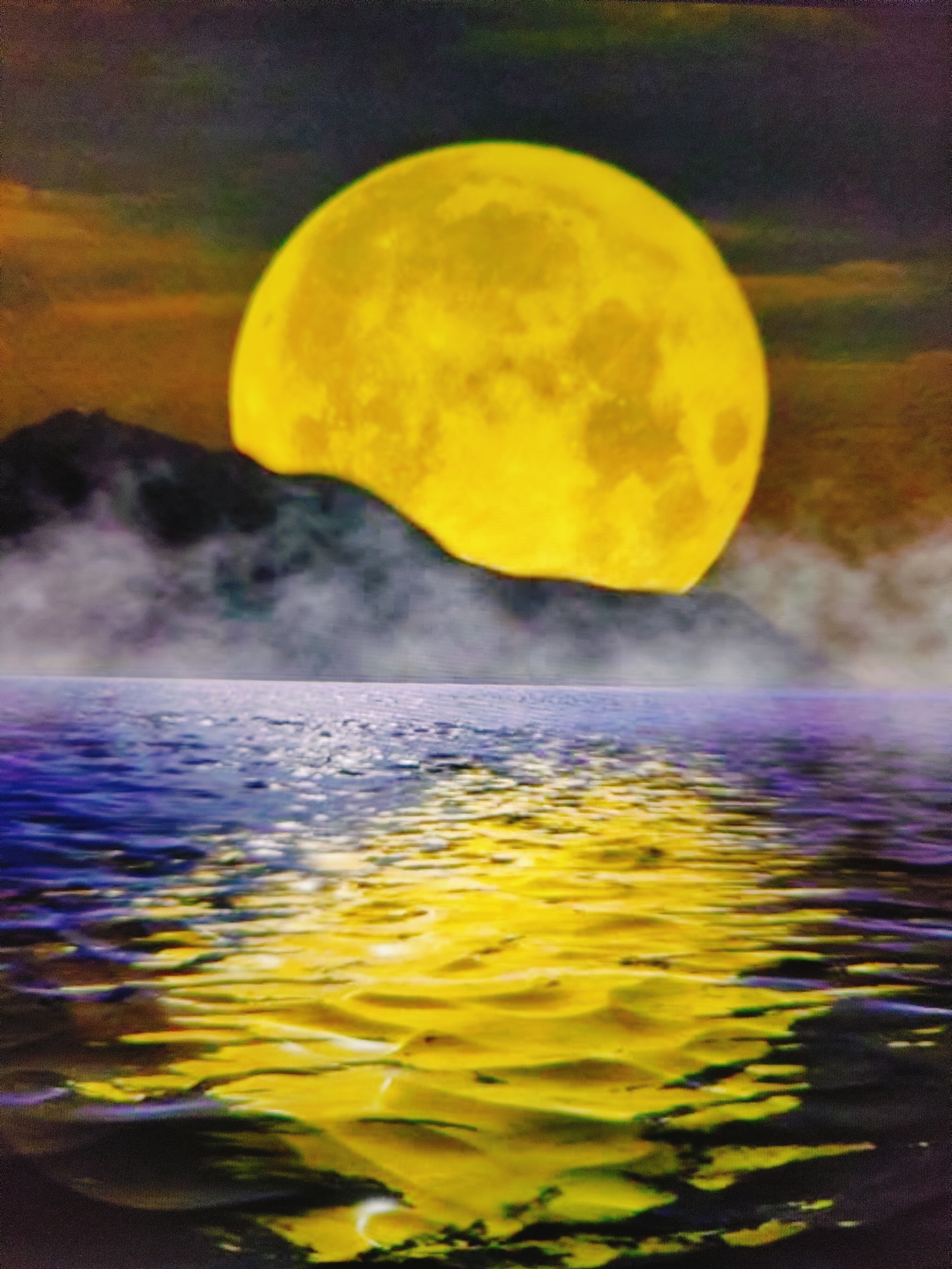 The image depicts a serene night scene with a prominent, large yellow moon hanging in a dark, cloudy sky. Below the moon, a dark, silhouetted mountain range is partially obscured by wispy clouds. In the foreground, a body of water, likely the Caspian Sea, reflects the moonlight and the colors of the sky. The water's surface is textured with ripples, creating a distorted yet beautiful reflection of the moon and surrounding landscape. The scene evokes a sense of tranquility and natural beauty. There are no people or man-made structures visible in the image. The location could be along the Baku coastline in Azerbaijan, given the presence of the Caspian Sea and potential mountainous terrain visible from the city.