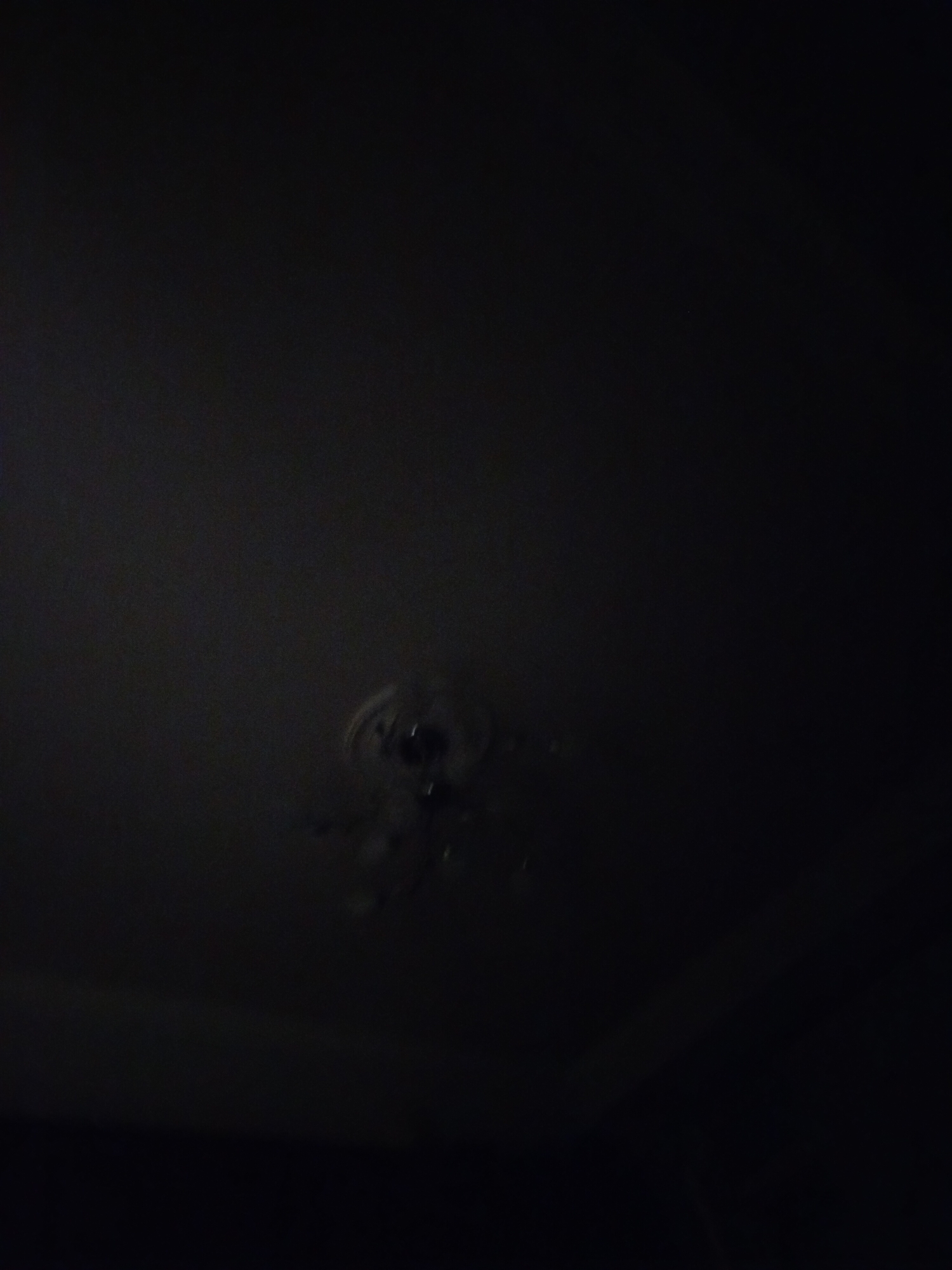 The image appears to be taken indoors, at night, and is very dark. A ceiling fan is visible in the center of the image, though it is poorly illuminated. The location in Yerevan, Armenia is not discernible from the image.