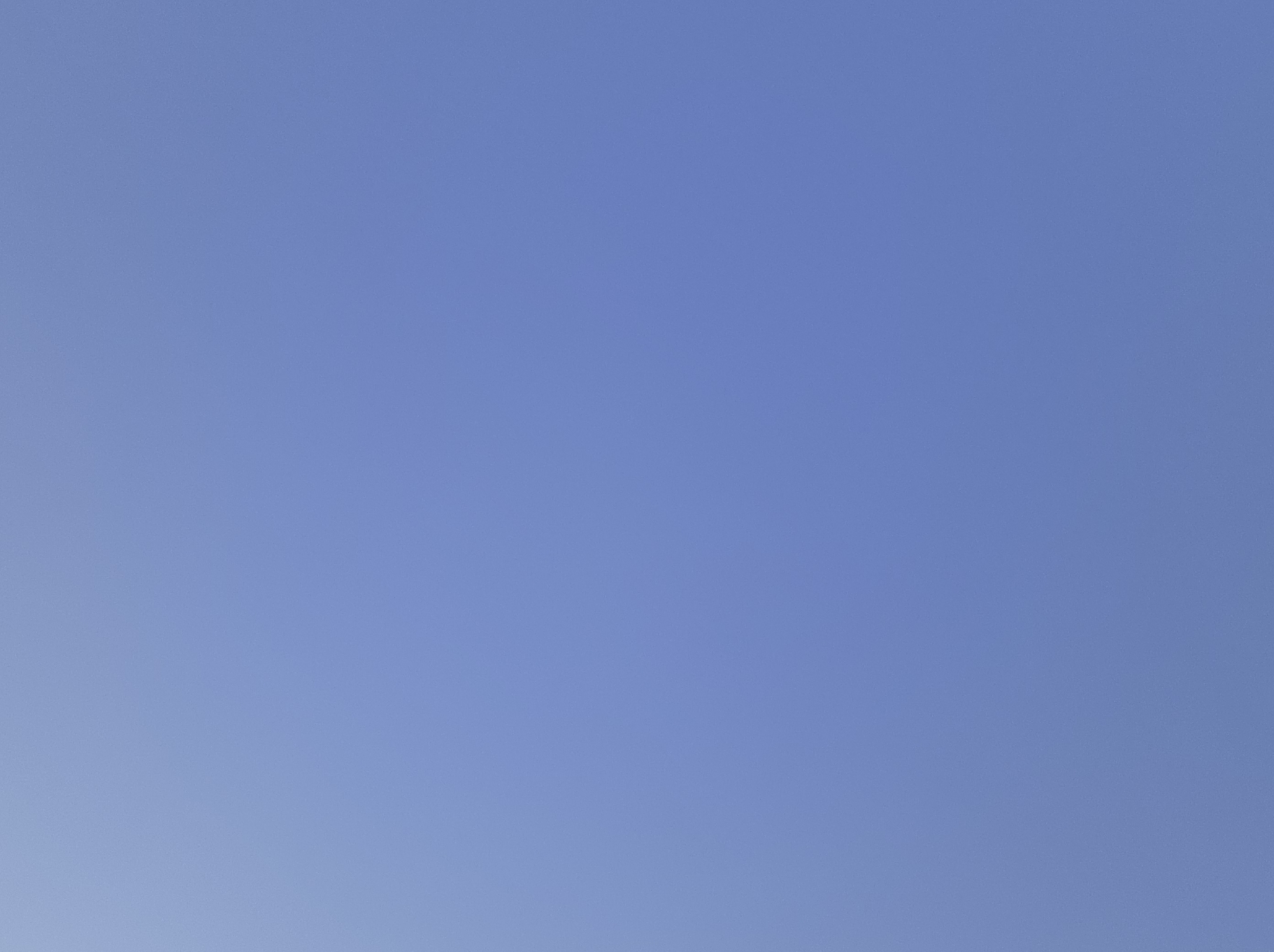 The image shows a clear, pale blue sky with no discernible features or objects. There is no indication of the city of Nariman, Kyrgyzstan, nor are there any people, subjects, objects, or actions depicted. The environment is simply an unobstructed sky.