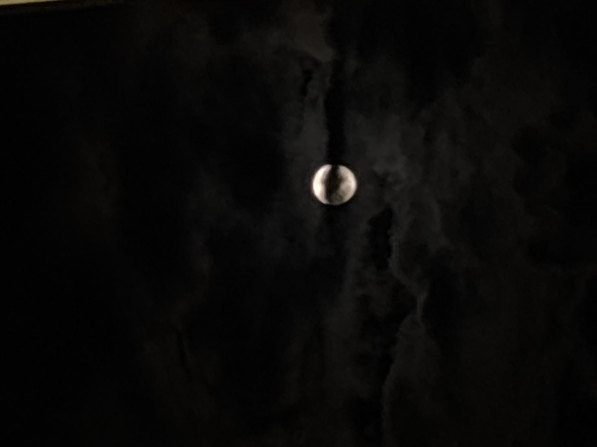 The image shows a crescent moon in a dark, cloudy sky. It is impossible to ascertain the location as Yerevan, Armenia, or any other specific location, based solely on the visual information in the provided image. No people, specific objects or actions other than the presence of the moon and clouds are visible.