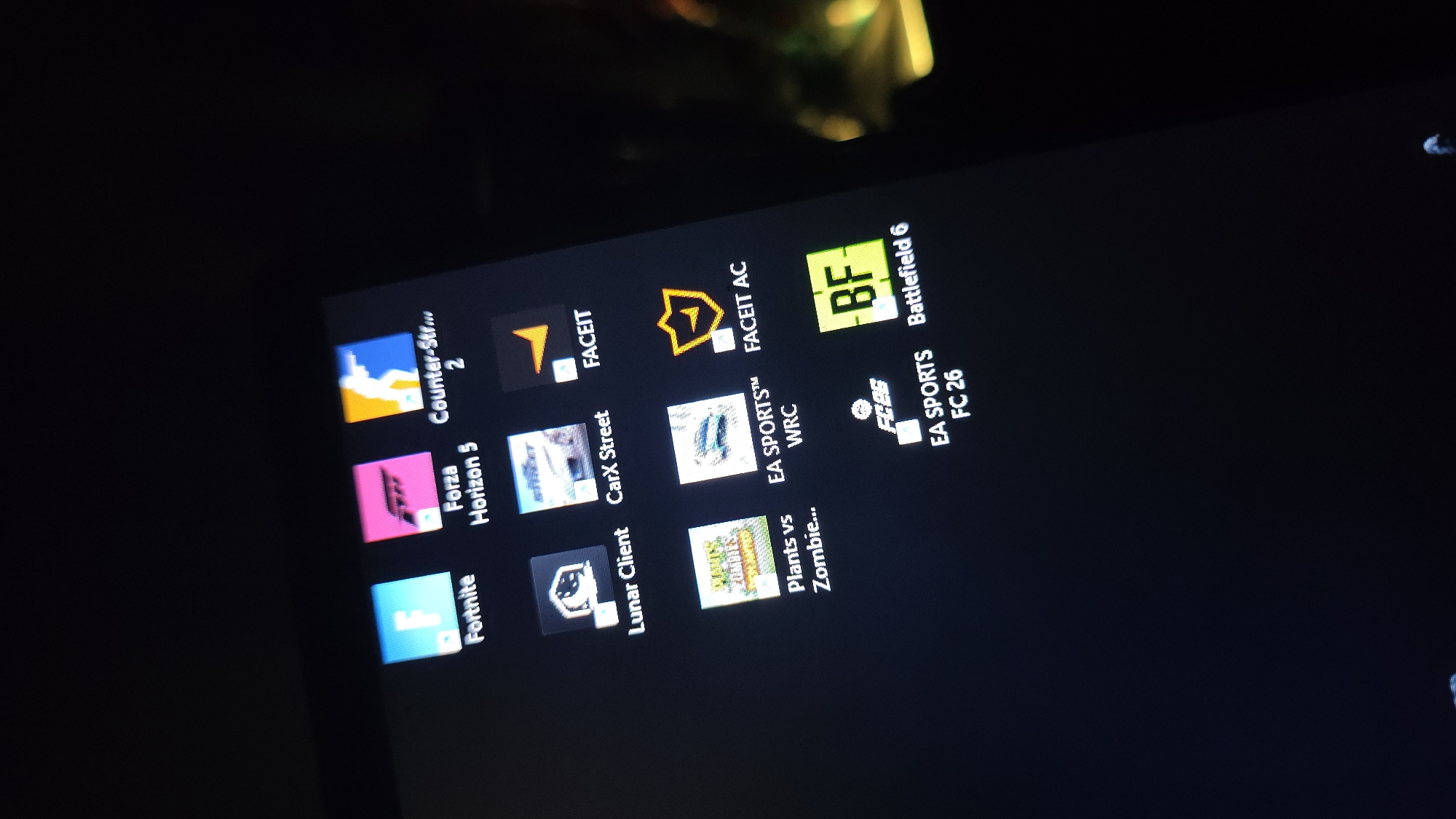 The image shows a screen displaying various application icons. The apps include Fortnite, Forza Horizon 5, Counter-Strike 2, Lunar Client, CarX Street, FACEIT, Plants vs Zombies, EA Sports WRC, FACEIT AC, Battlefield 6, and EA Sports FC 26. The setting of the image is not identifiable, and there is no evidence to suggest a location in Rüsselsheim am Main, Germany. There are no people visible and no specific actions or interactions occurring in the frame.