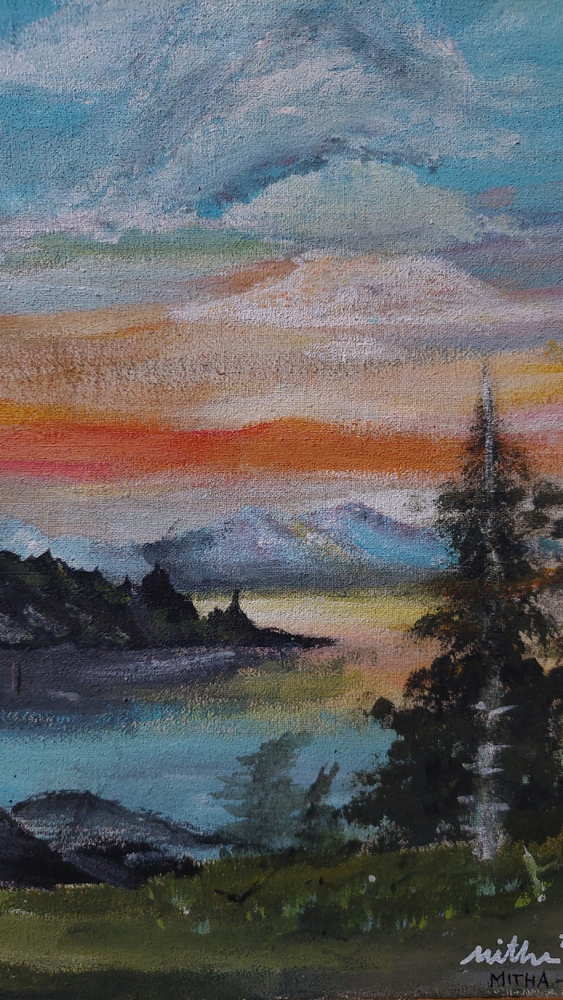 The image is an oil painting of a landscape with a body of water, mountains, trees, and a colorful sky. The sky is a gradient of blue, white, orange, and pink, suggesting a sunset or sunrise. In the foreground, there is a body of water that reflects the colors of the sky. Dark green trees and silhouetted mountains are visible on the far bank of the water, with more distant, hazy mountains in the background. A tall, dark green pine tree stands on the right side of the painting. The painting is signed "micha" and "MITHA" in the lower right corner. The style of the painting is impressionistic, with visible brushstrokes. The painting depicts a serene natural scene. There is no indication of the city of Bojong Gede, Indonesia, in the image itself.