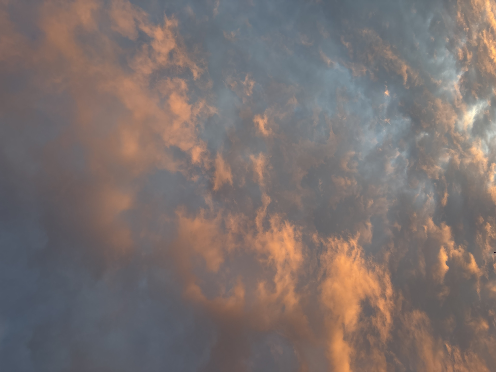 The image shows a sky with a mix of dark gray and orange clouds. The orange color likely comes from the setting or rising sun. The clouds are relatively dense and cover most of the sky. There is no indication of a specific location in Moscow, Russia, or of any people or objects in the scene. The overall impression is that of a dramatic sunset or sunrise.