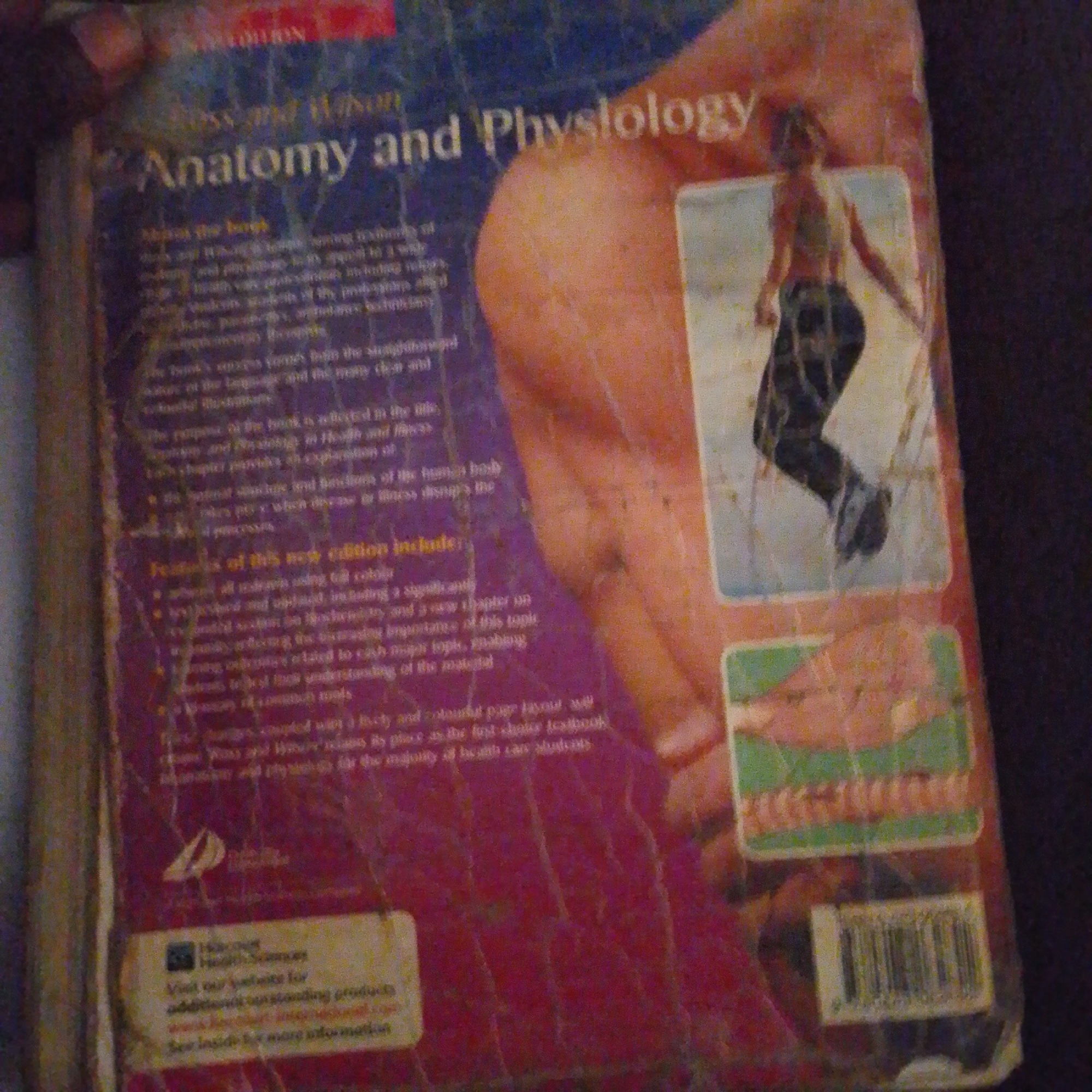 The image shows the cover of a book titled "Anatomy and Physiology." The cover features a close-up of a person's leg and thigh, with the book's title prominently displayed in large, white, sans-serif font. There is also a smaller image of a person in athletic wear. The background is a textured, purple fabric. The book appears to be in good condition, with some minor scuffing on the cover. There is no visible indication of the city of Jalingo, Nigeria, or any specific environmental details related to that location. The image is a close-up of a book cover and does not depict an outdoor scene or a city.
