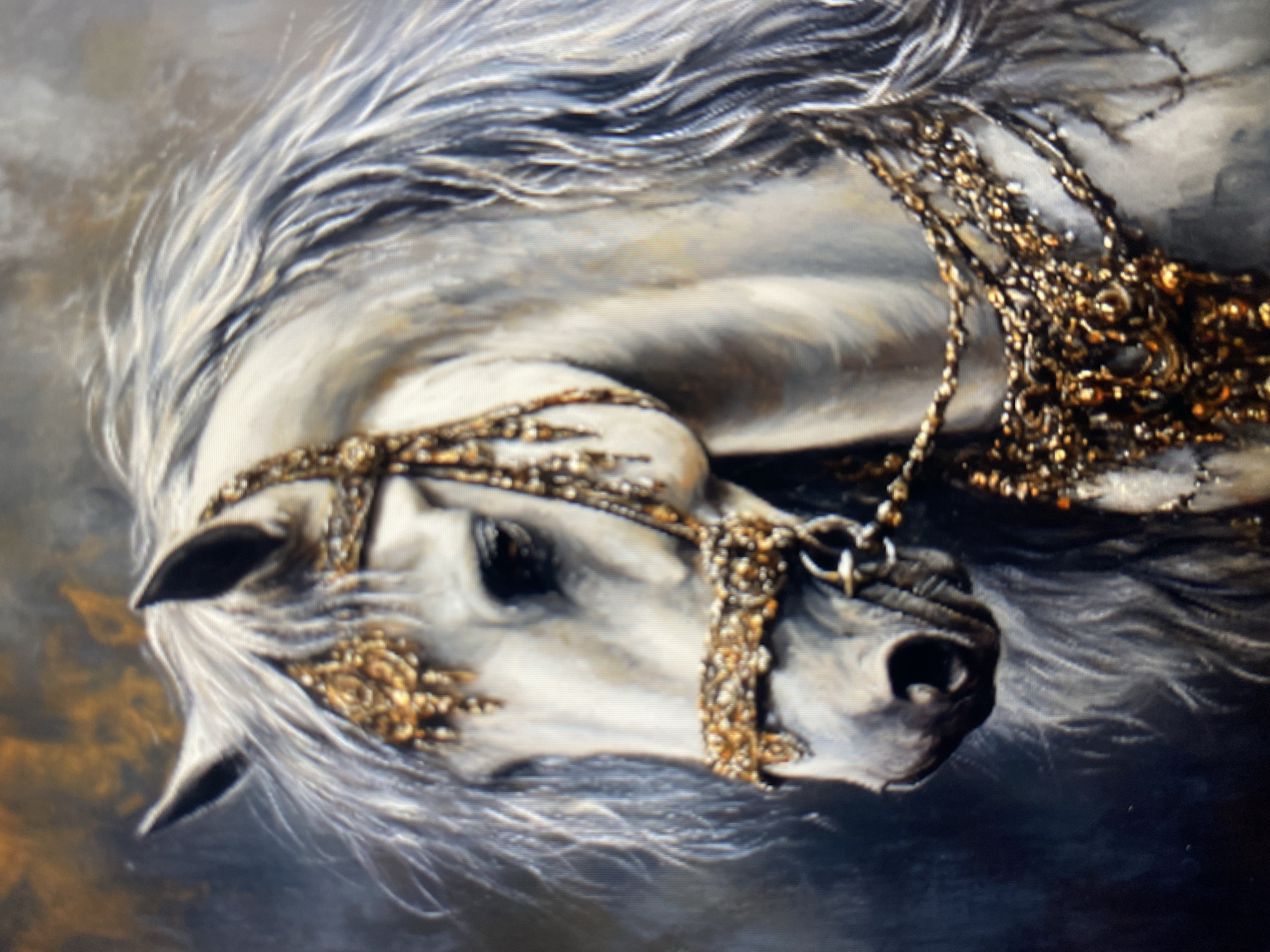 This is a close-up, head-and-shoulders oil painting of a white horse adorned with ornate gold and jewel-encrusted tack. The horse's head is turned to the left, and its long, flowing mane is depicted in shades of white and gray. The background is a dark, atmospheric blend of grays, blues, and hints of gold, suggesting a dramatic or regal setting. The tack includes a decorative bridle with elaborate detailing around the eyes and muzzle, and a heavy, layered chest piece composed of chains and jewel-like accents. The painting is highly detailed, focusing on the texture of the horse's coat, mane, and the intricate craftsmanship of its adornments. The lighting is dramatic, with highlights on the horse's face and tack, and deep shadows in the background.