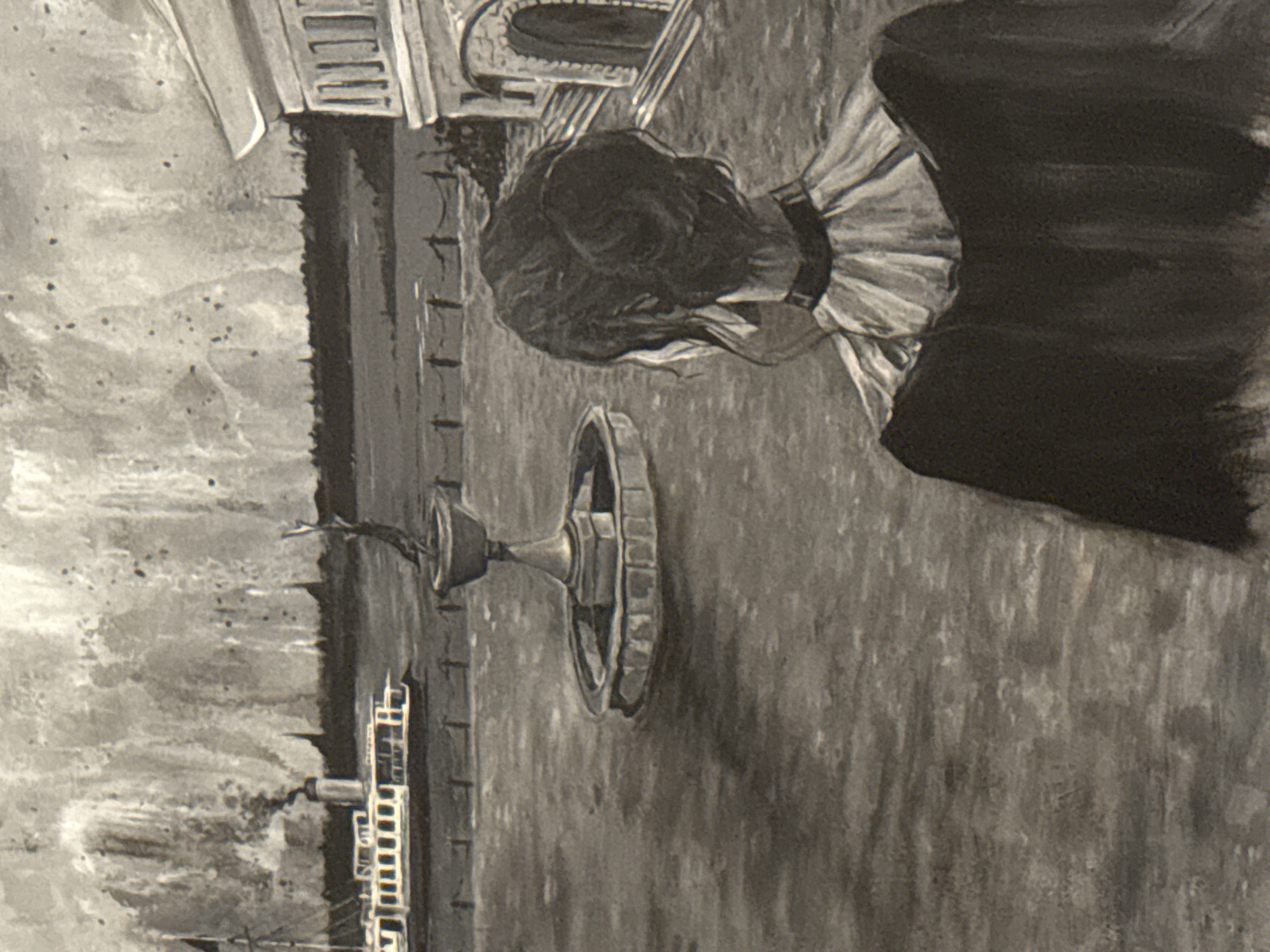The image depicts a black and white scene featuring a woman in what appears to be a period costume, standing in an outdoor setting. The woman is wearing a ruffled collar and a dark dress. Behind her, there is a fountain with a wheel-like structure. Further in the background, a building is visible with architectural details such as arched windows and a staircase. The setting has been identified as the city of Sarapul, Russia. There are trees along a darker horizontal line on the left.