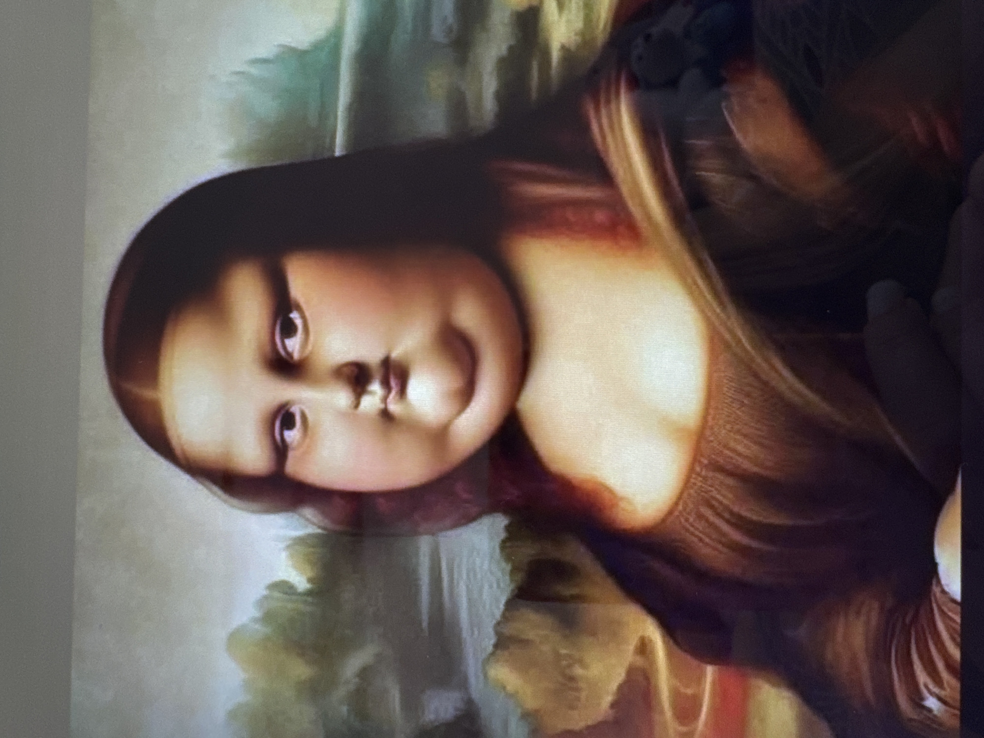The image is a digital rendering of Leonardo da Vinci's Mona Lisa, depicted with exaggerated features, making her appear significantly overweight. Her face is round and fleshy, with prominent jowls and a double chin. Her eyes are wide, and her lips are pursed. She is wearing a dark, low-cut dress with folds and ruffles, similar to the original painting. The background is a hazy landscape with trees and a body of water, also reminiscent of the original. There is no indication of the location being the city of Yalta, Ukraine.