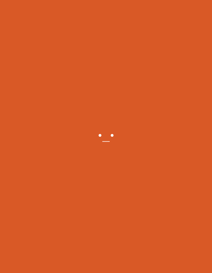 The image is a minimalist graphic with a solid orange background. Centered in the image, slightly above the vertical middle, is a simple representation of a face. It consists of two small white dots for eyes and a short white horizontal line below them for a mouth. There is no discernible urban environment or location identifiable in the image.