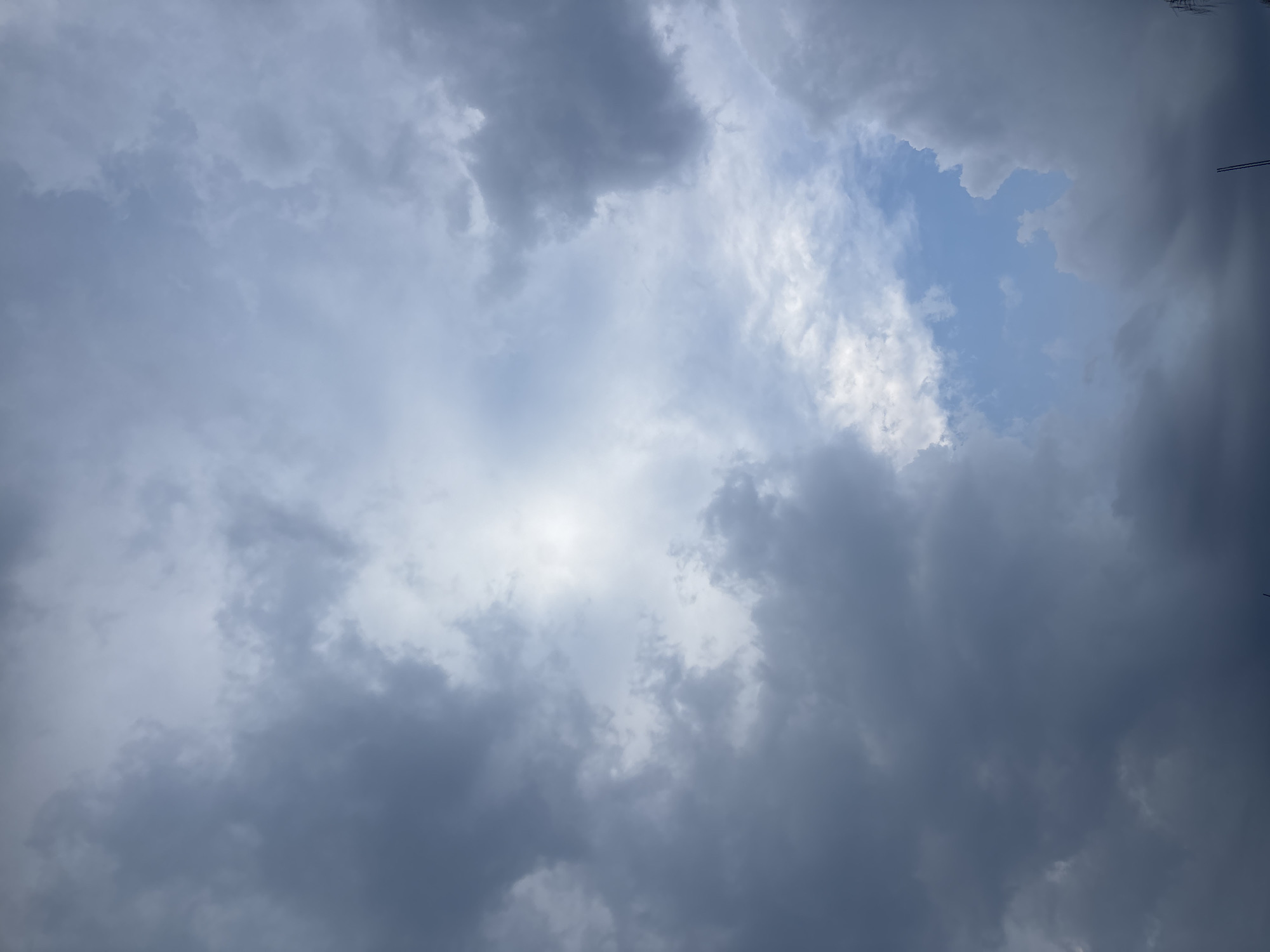 The image shows a sky filled with clouds. Some areas reveal patches of blue sky. The clouds are varying shades of gray and white. The location in the city of Puebla, Mexico is unknown.