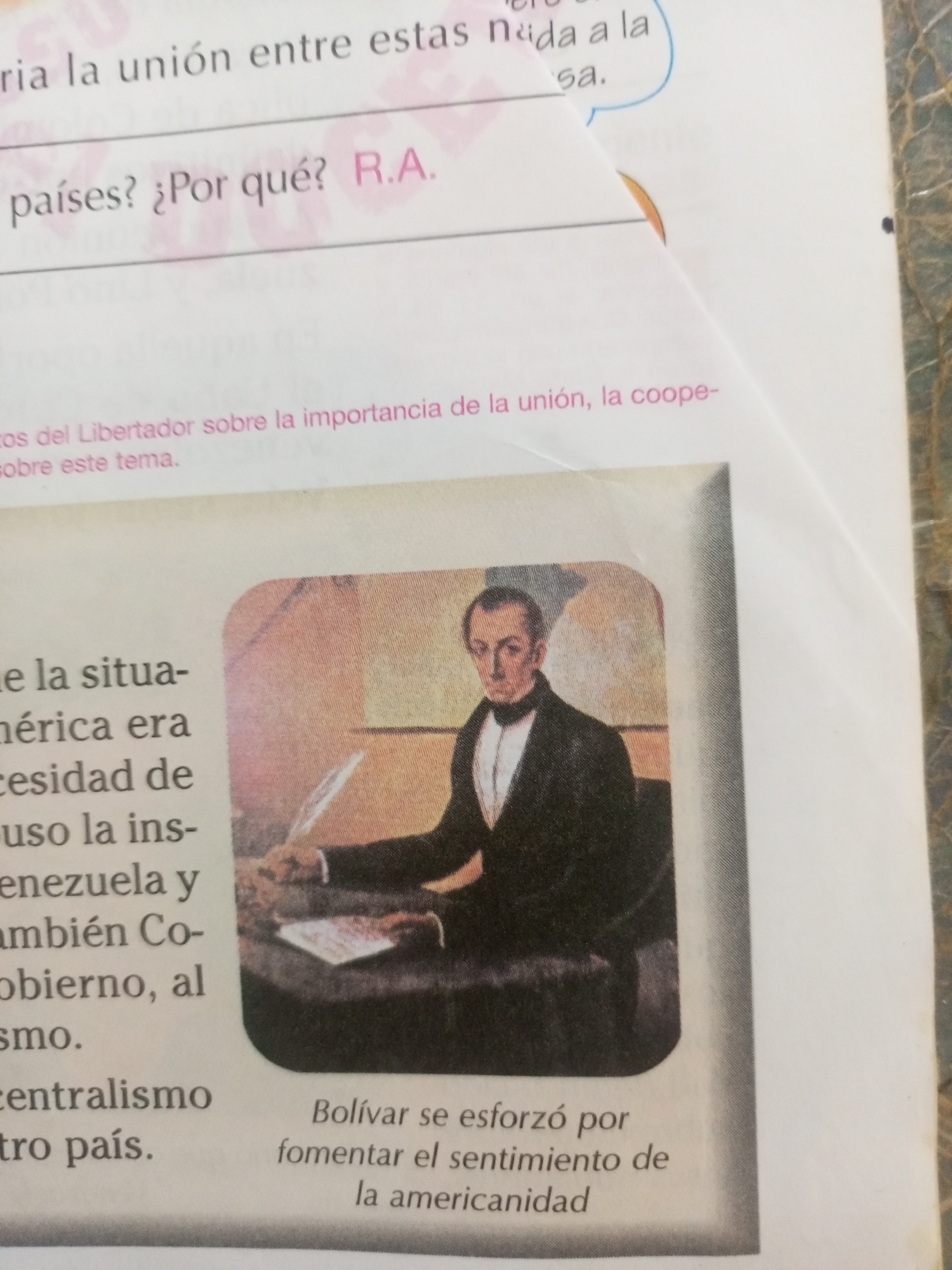 The image shows a page from a book or magazine with text and a portrait of a man. The text at the top reads, "ria la unión entre estas nada a la sa." Below that, it says, "¿Por qué? R.A." and "países?". Further down, there is text that says, "cos del Libertador sobre la importancia de la unión, la coope- sobre este tema."
The main visual element is a portrait of a man in formal attire, appearing to be signing a document. He is wearing a dark suit jacket, a white shirt, and a black bow tie. The portrait is set within a rounded frame. Below the portrait, there is text that reads, "Bolívar se esforzó por fomentar el sentimiento de la americanidad."
The image does not contain any information about the city of La Tagua, Venezuela.
