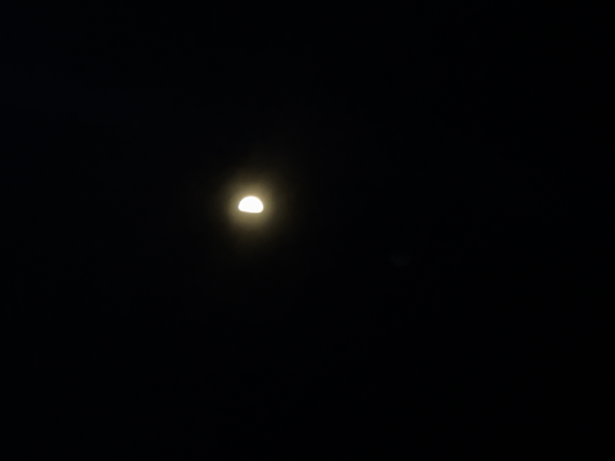 A half-moon is visible in a dark, seemingly cloudless night sky. The location in Hatne, Ukraine is not discernible from the image.